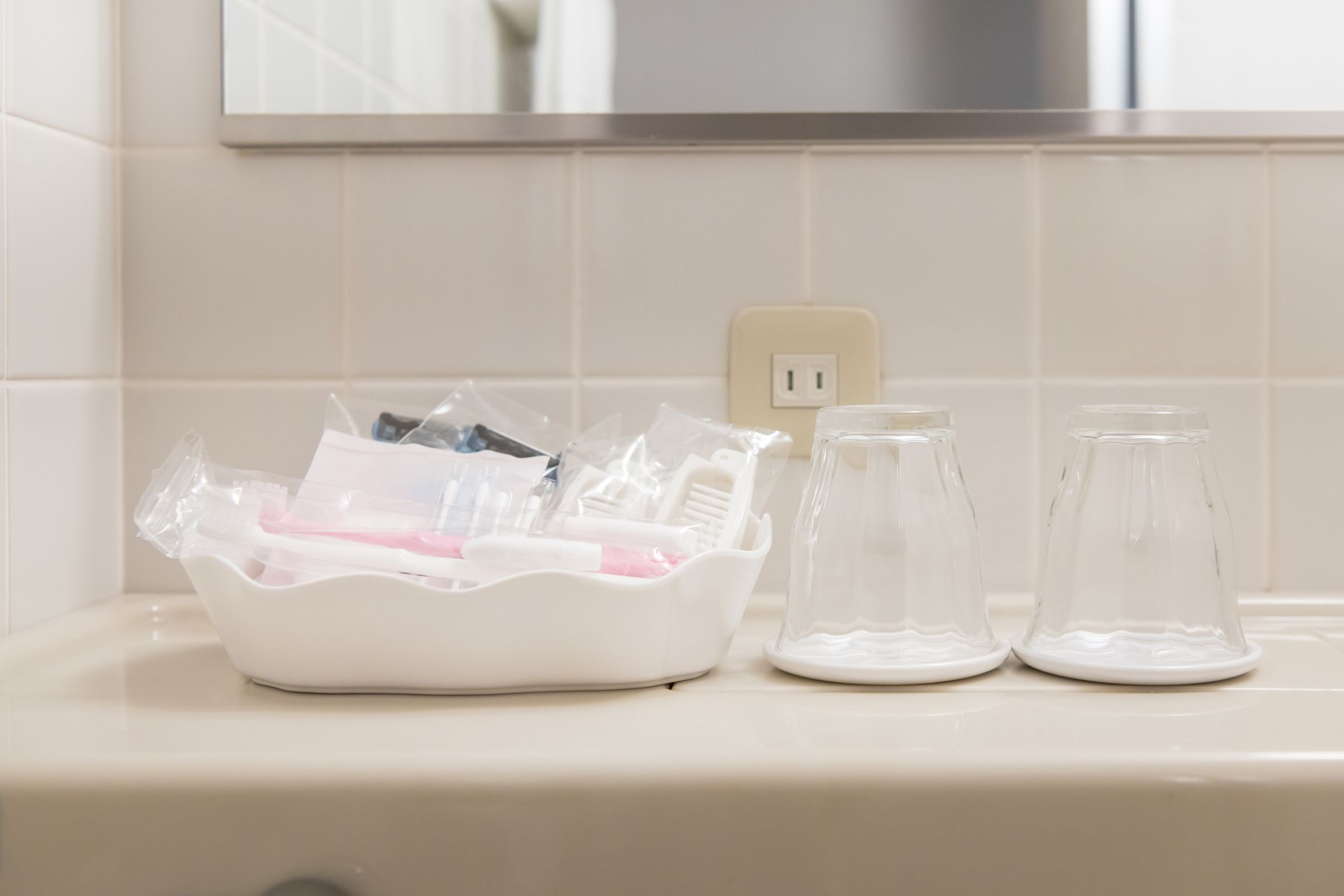 toiletry bag with travel toiletries, small plastic bottles of hygiene products and soap, Hotel Guest Room Supplies