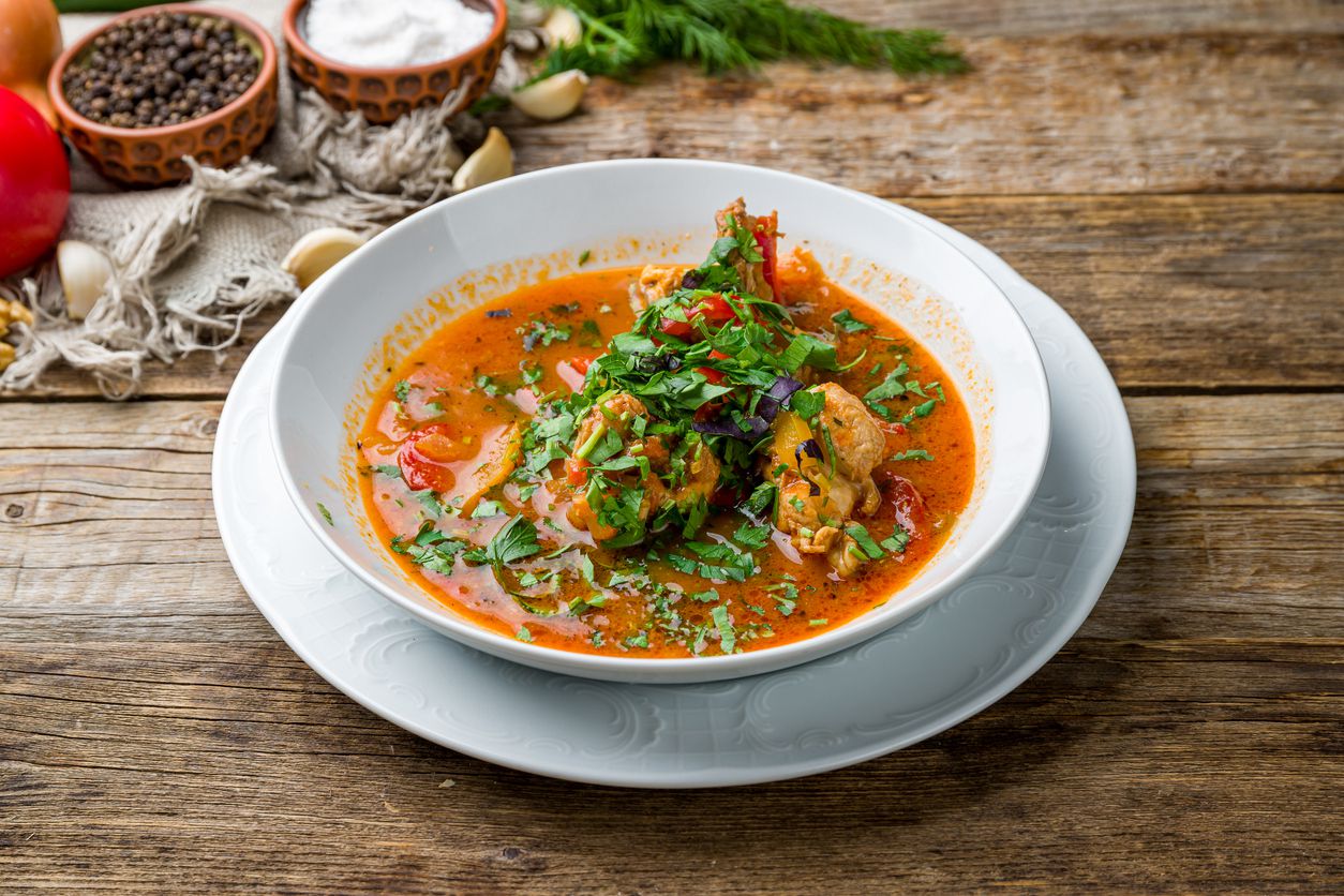 Chakhokhbili chicken Georgian cuisine on wooden table