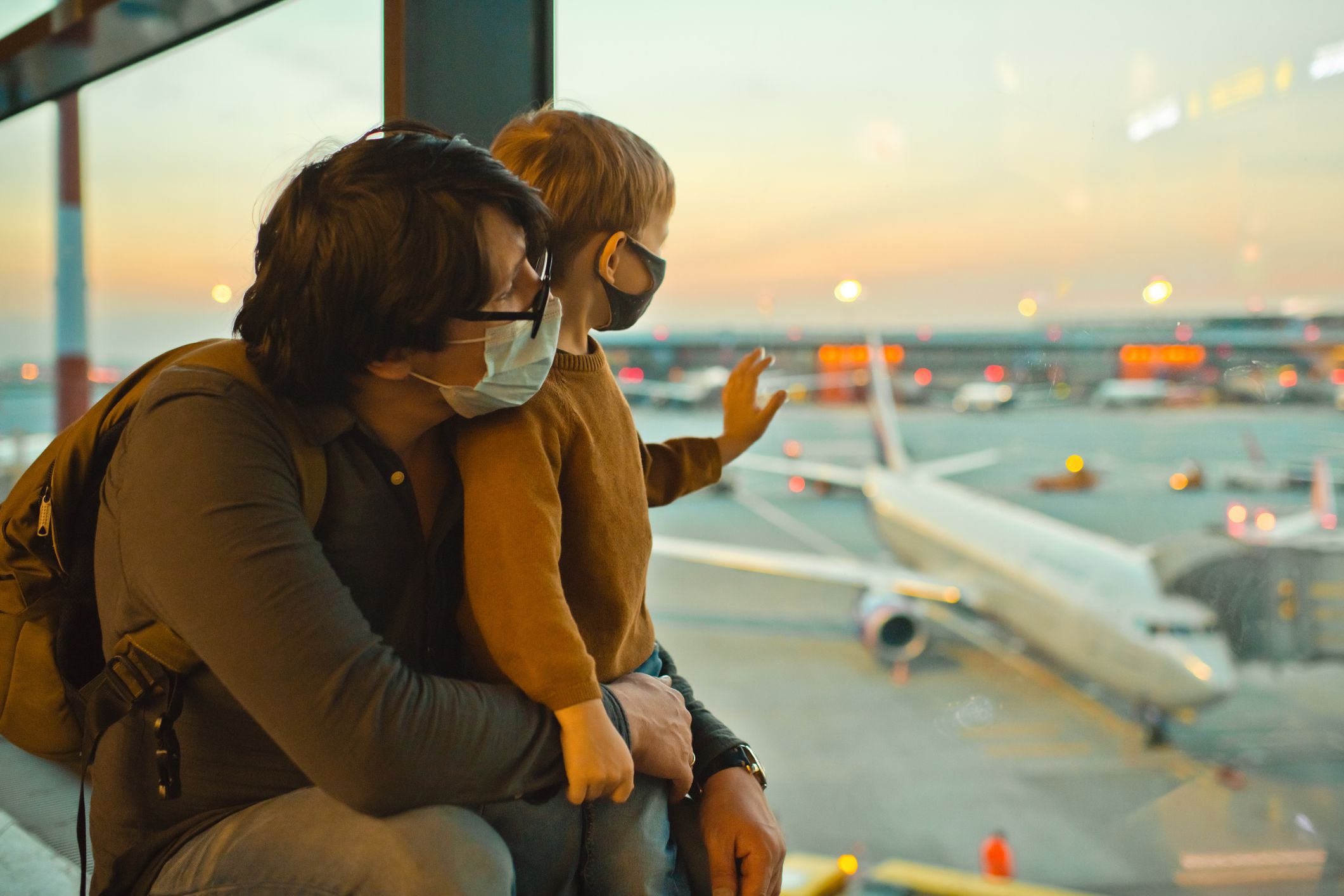Father and son traveling by plane