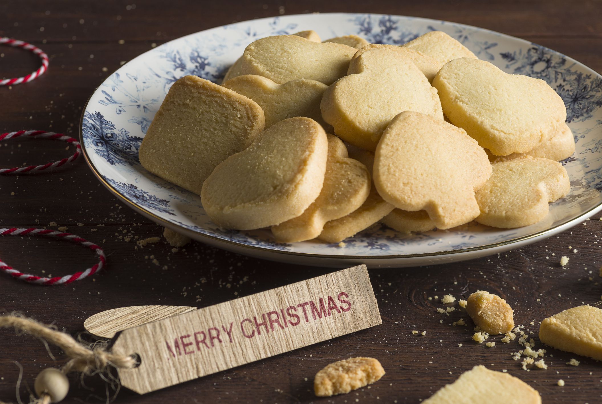 Assorted cookies on a wooden table. Front view. Some the ingredients used to make cookies are eggs, flour, sugar, butter.