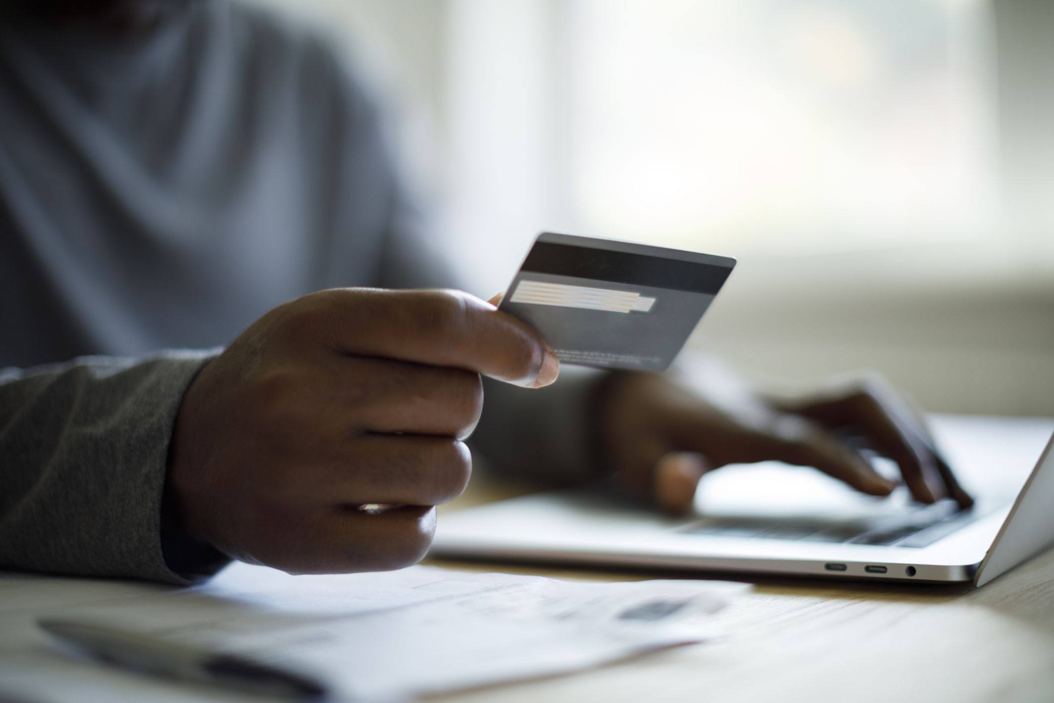 Man using credit card and laptop for online shopping