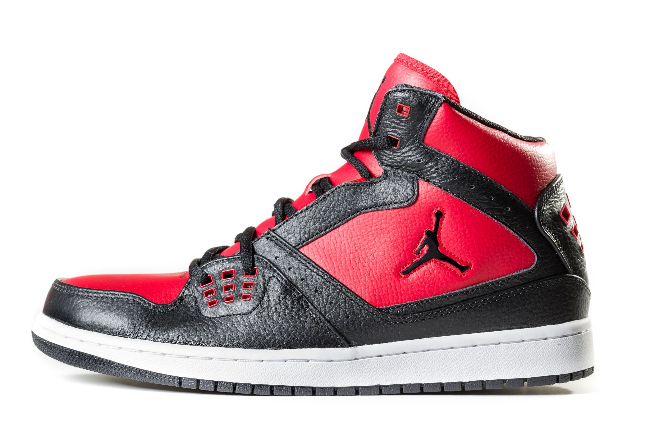 New York, USA - November 22, 2012: Black Air Jordan sneaker isolated on white background. Air Jordans are a brand of shoes and athletic apparel designed and produced by Nike for the now-retired basketball player Michael Jordan.