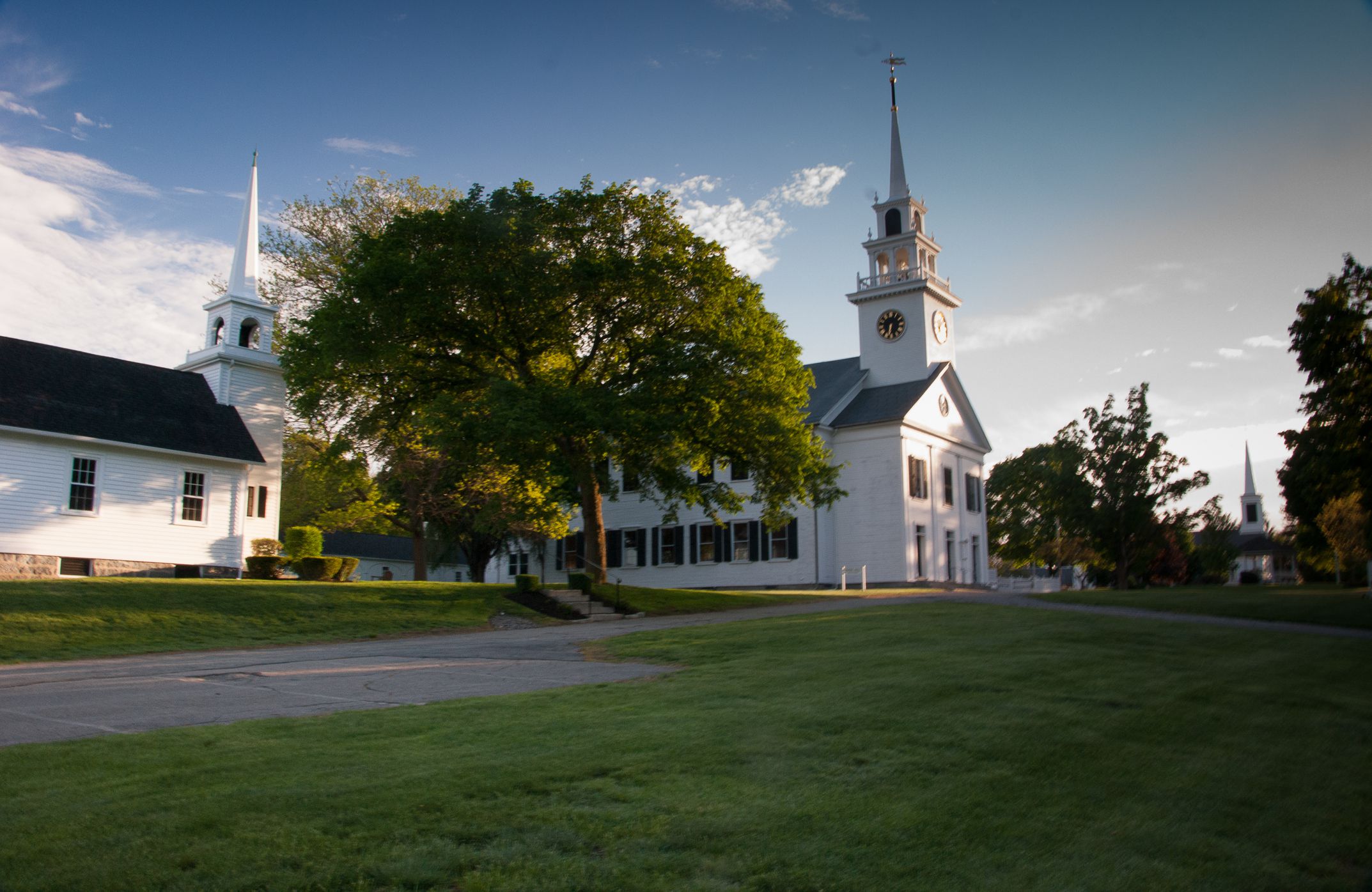 Three white churches and steeples next to the Town Common, Milton, MA