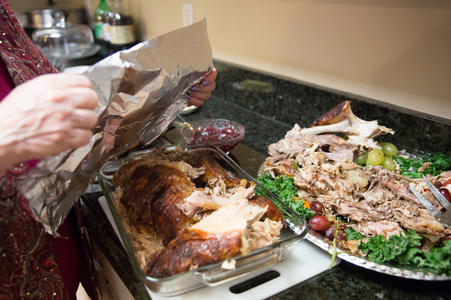 hands wrapping turkey leftovers