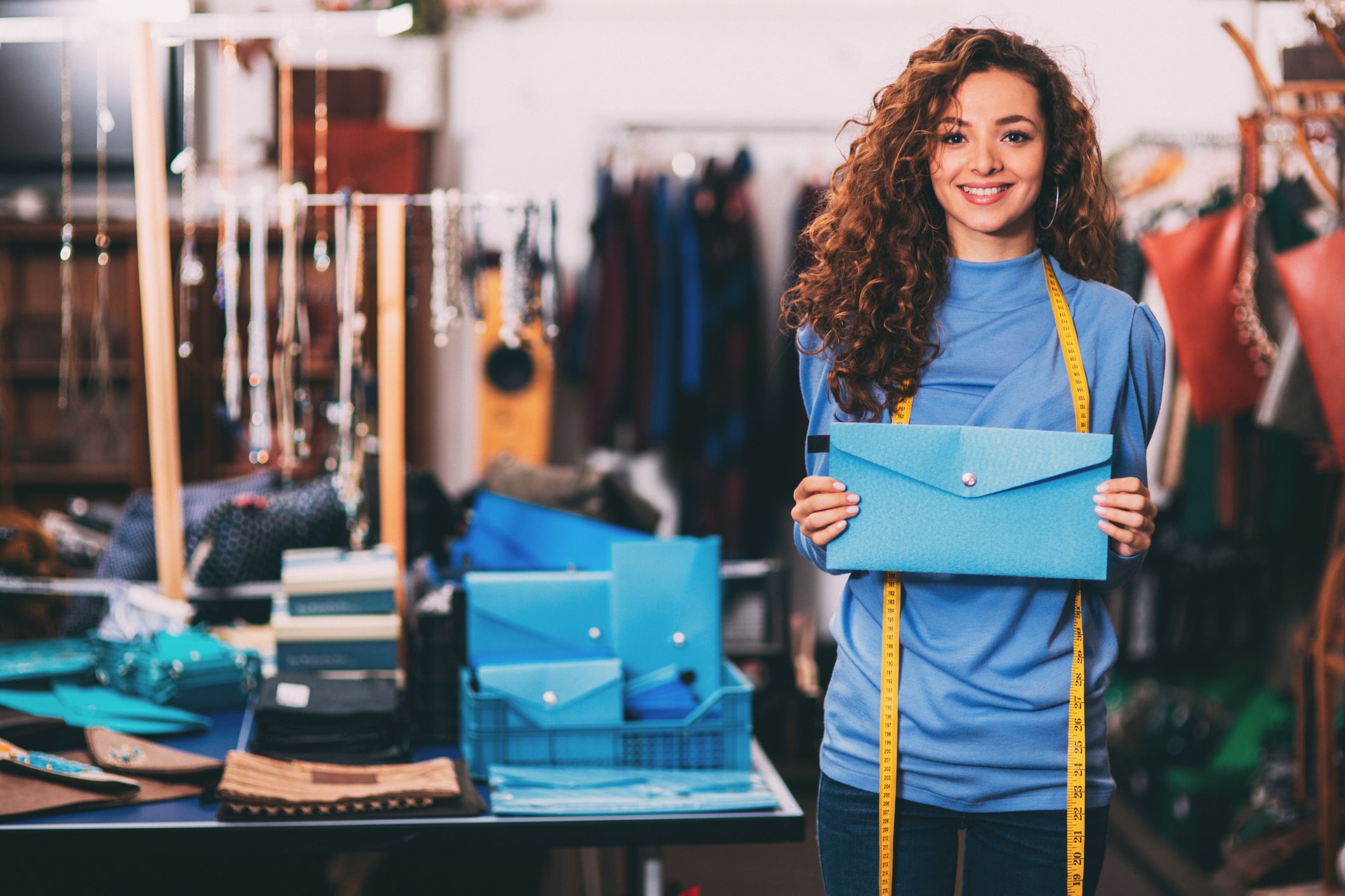 Designer showing a bag.