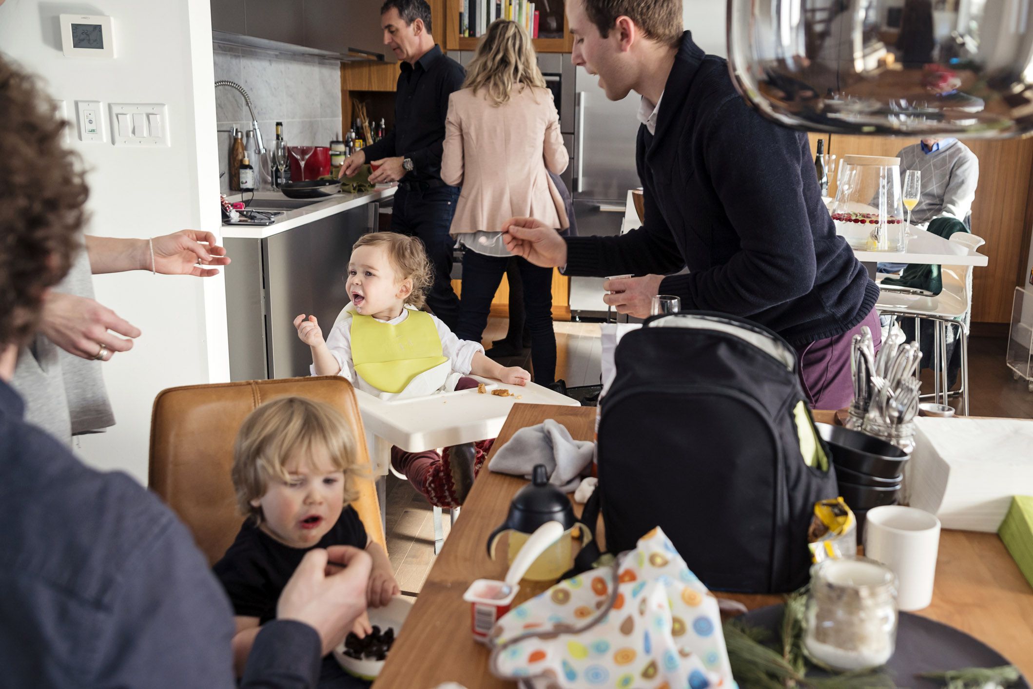 family in kitchen at crowded apartment