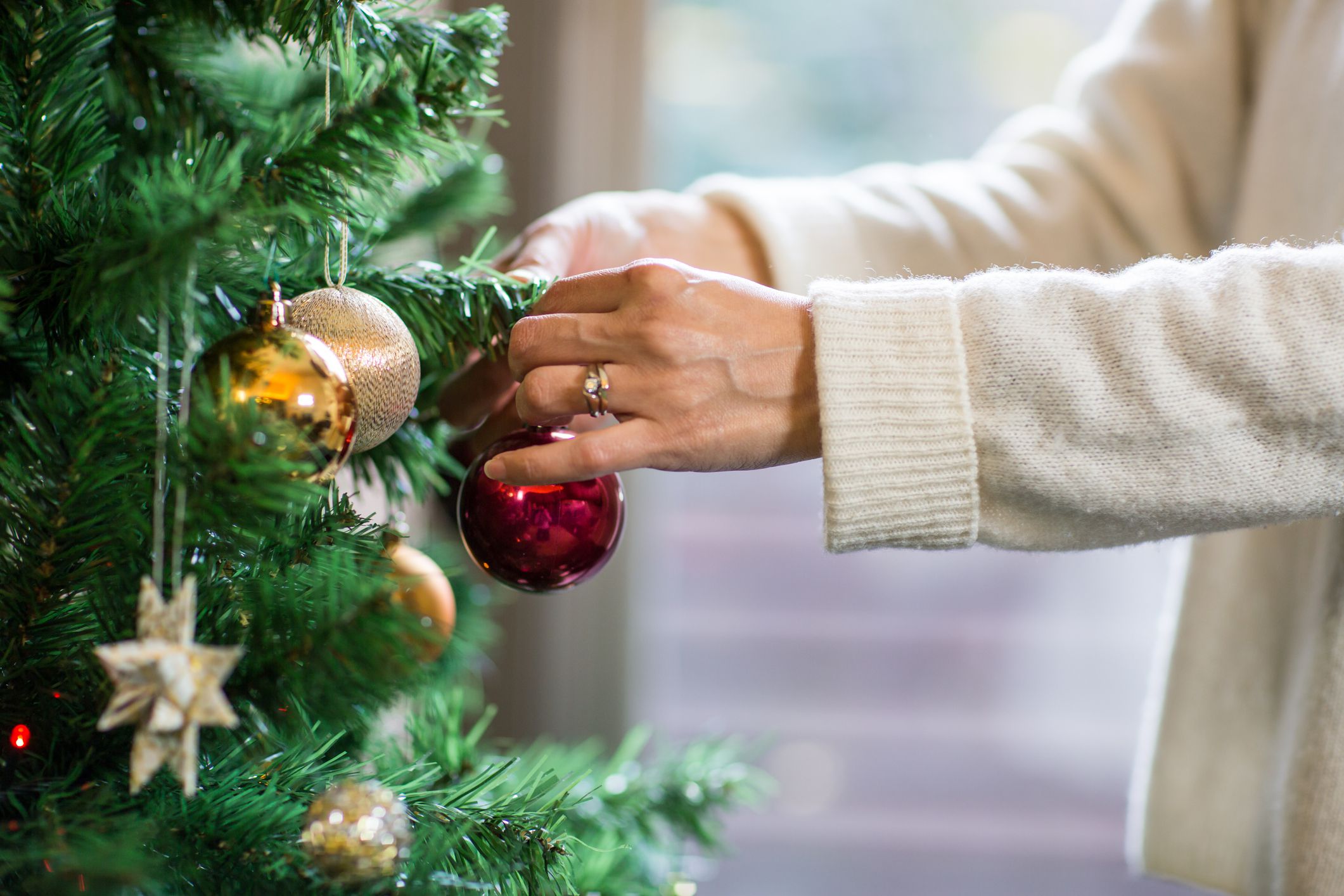 hands taking down christmas ornament
