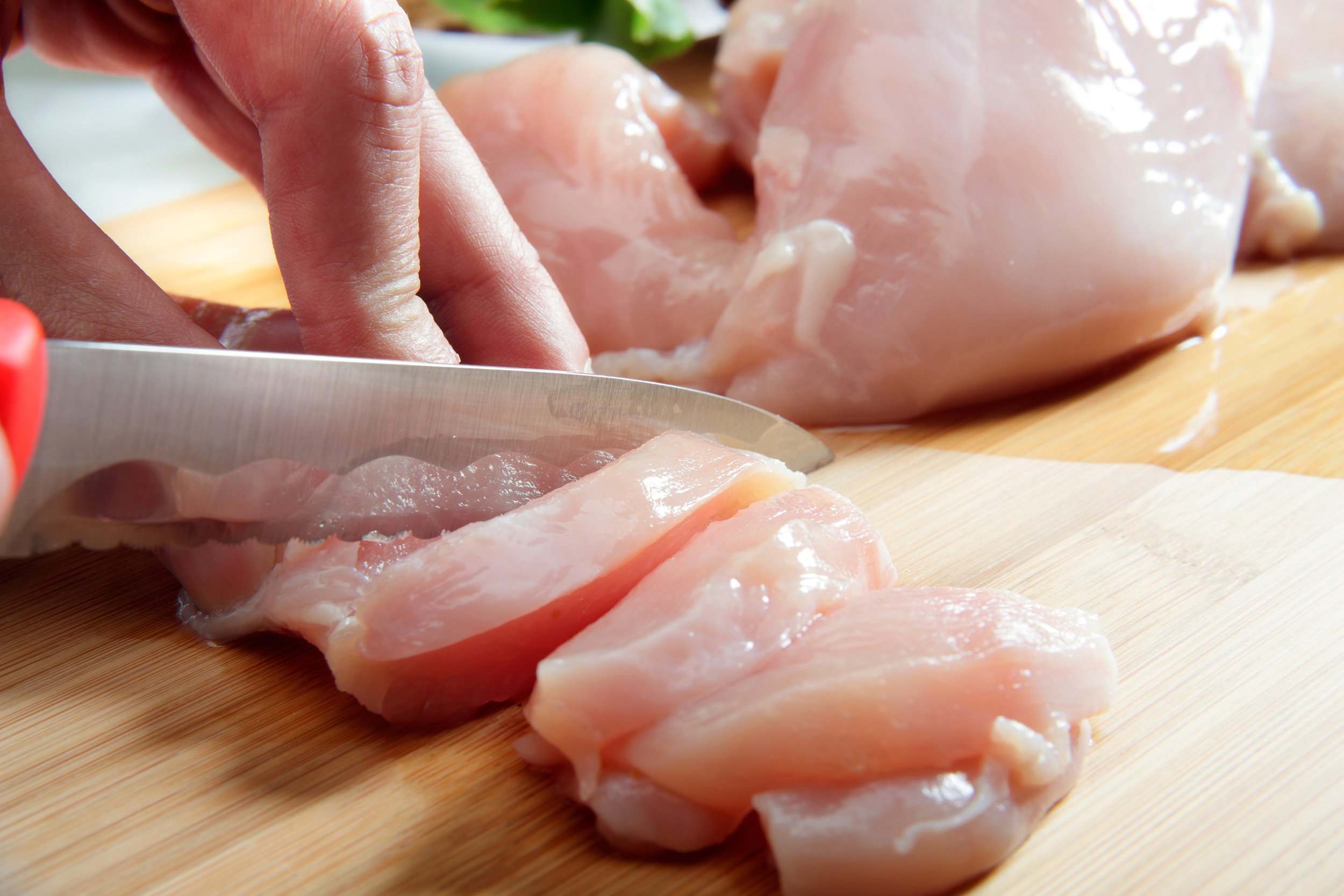 Slicing raw chicken