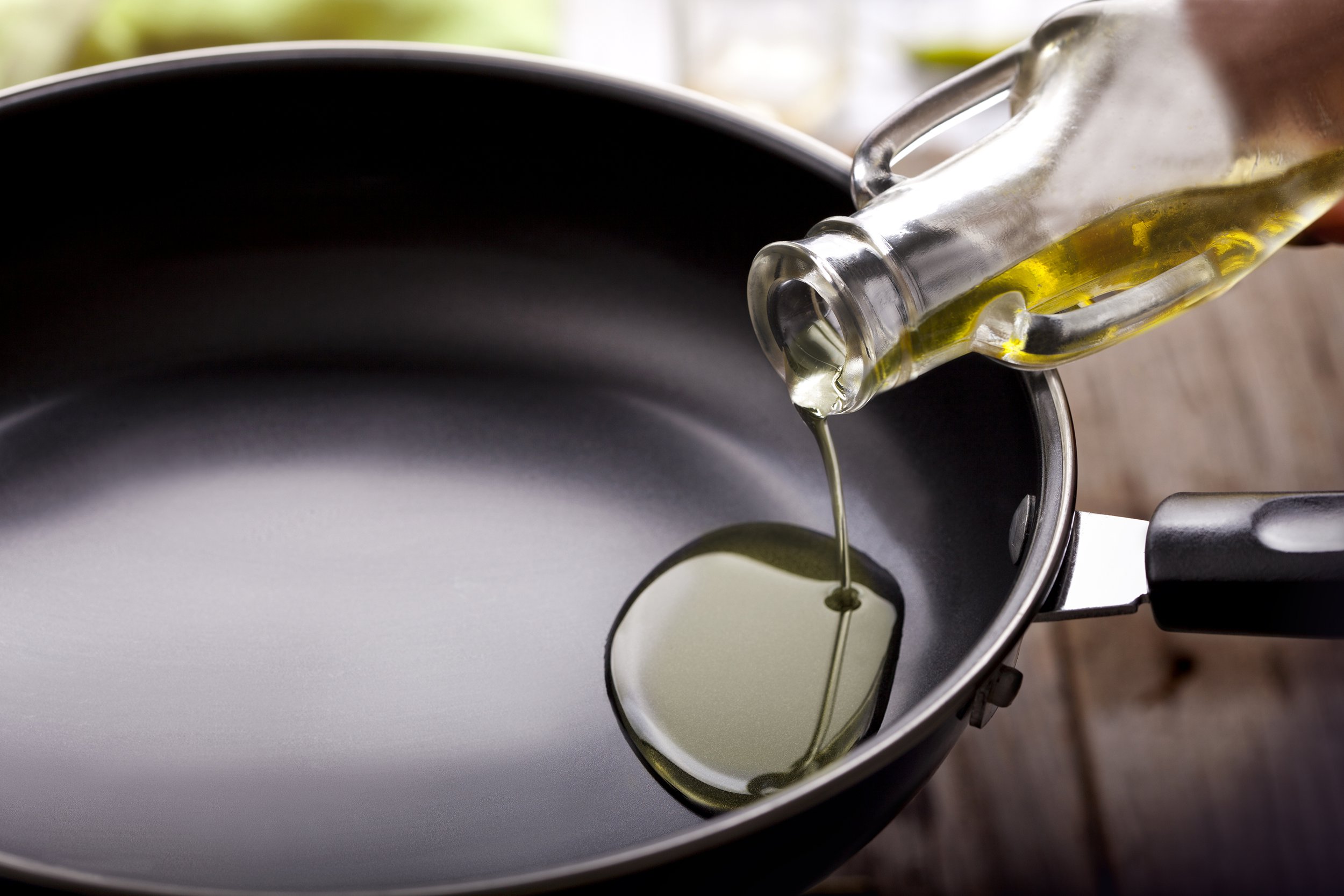 Pouring oil into a frying pan