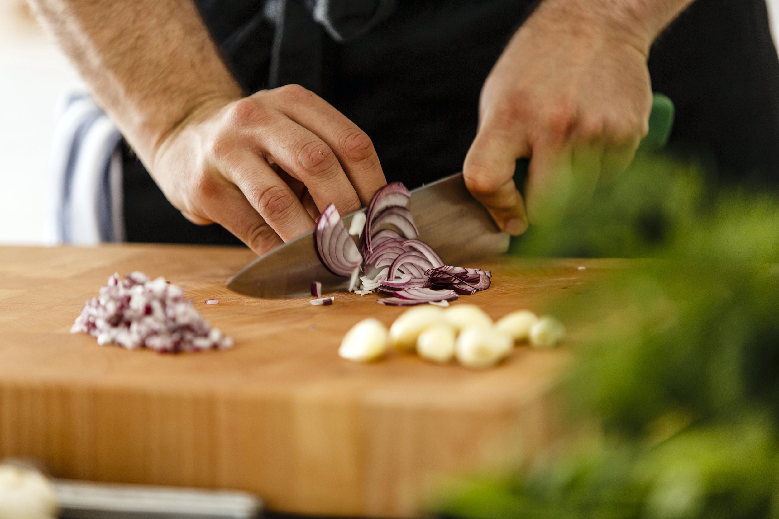 Man chopping red onions