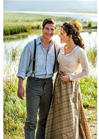 When Calls the Heart Erin Krakow as Elizabeth Thatcher and Daniel Lissing as Jack Thornton in front of a pond
