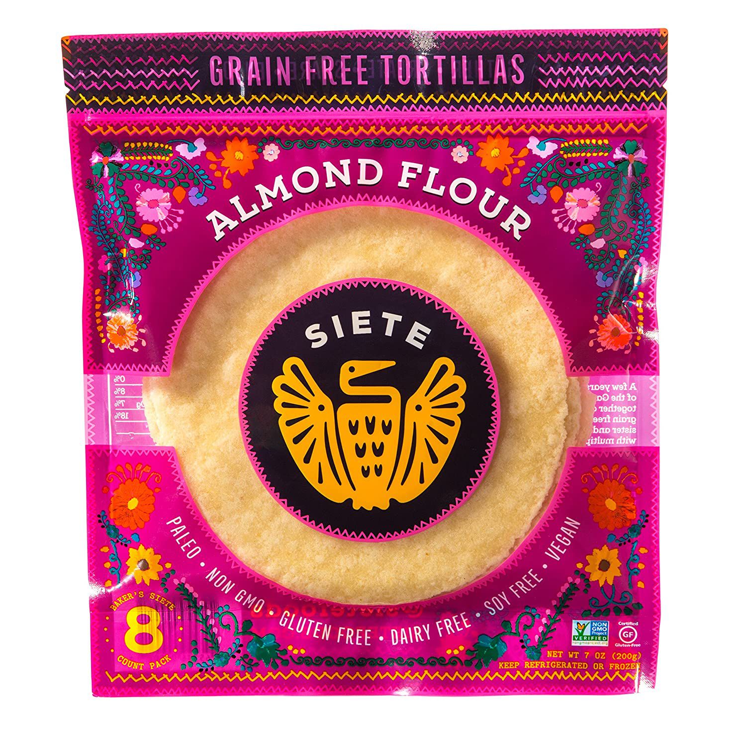 A colorful package of Siete almond flour grain-free tortillas. The front features a yellow bird logo, floral designs, and labels: paleo, non-GMO, gluten free, dairy free, soy free, vegan. The pack contains 8 tortillas.