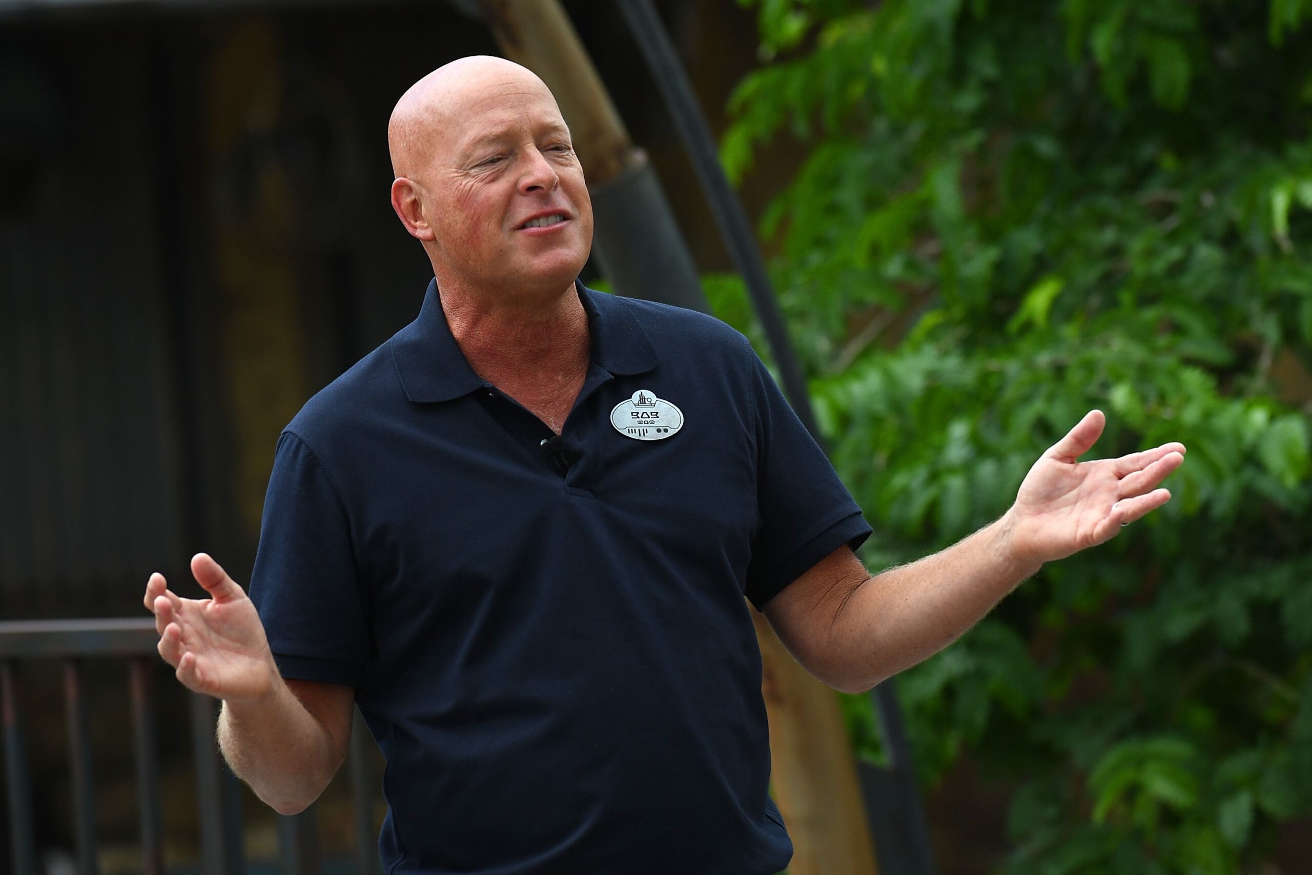 Bob Chapek speaks during the Star Wars: Galaxy's Edge Dedication Ceremony at Disney’s Hollywood Studios, Orlando, Florida, 2019, blurred background of green foliage