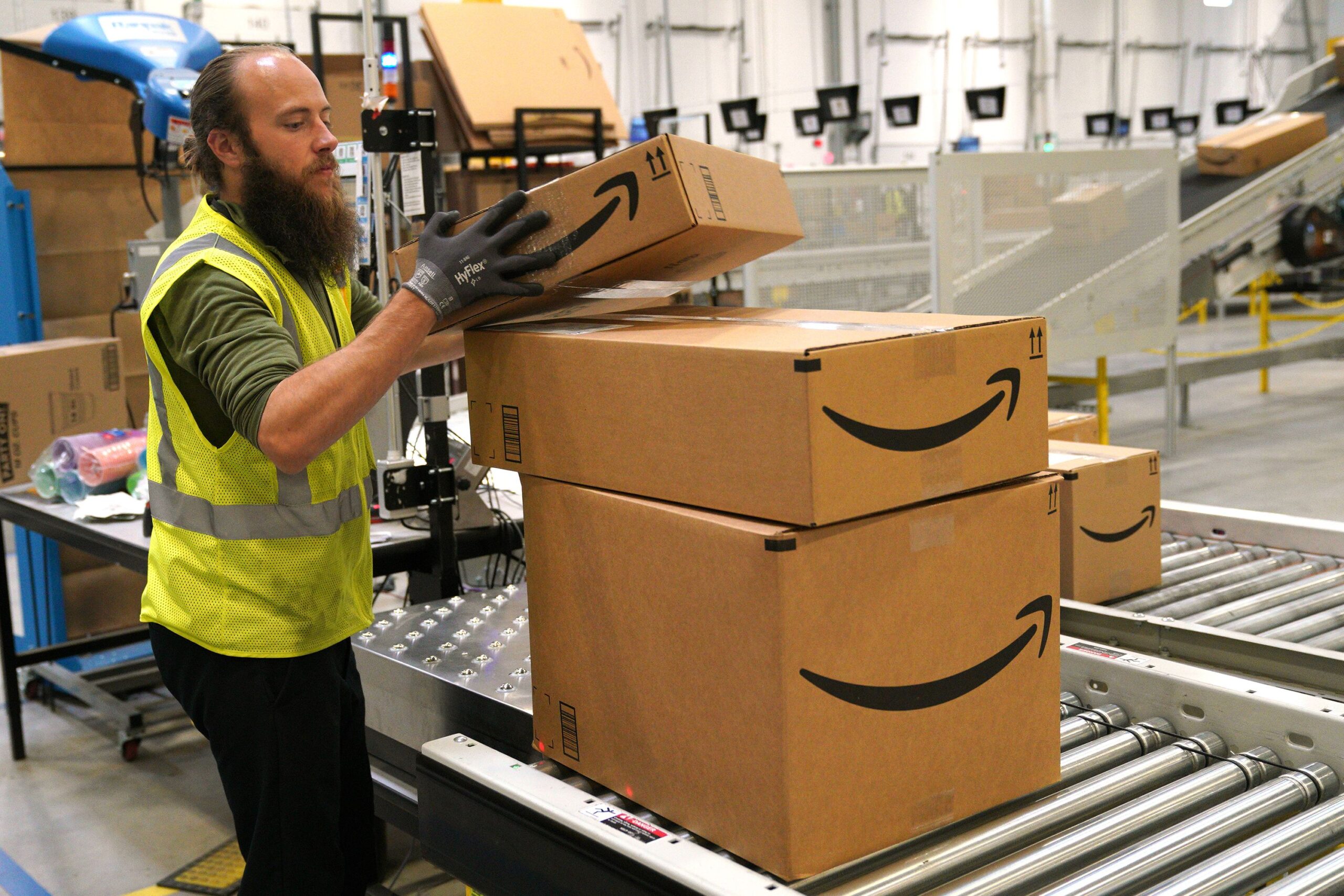 A worker moves packed boxes at the Amazon fullfillment center May 3, 2018 in Aurora, Colorado