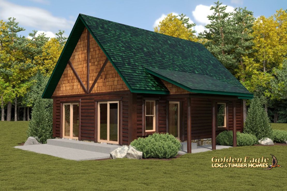 Golden Eagle Log Homes cabin on a grass lawn with trees behind it