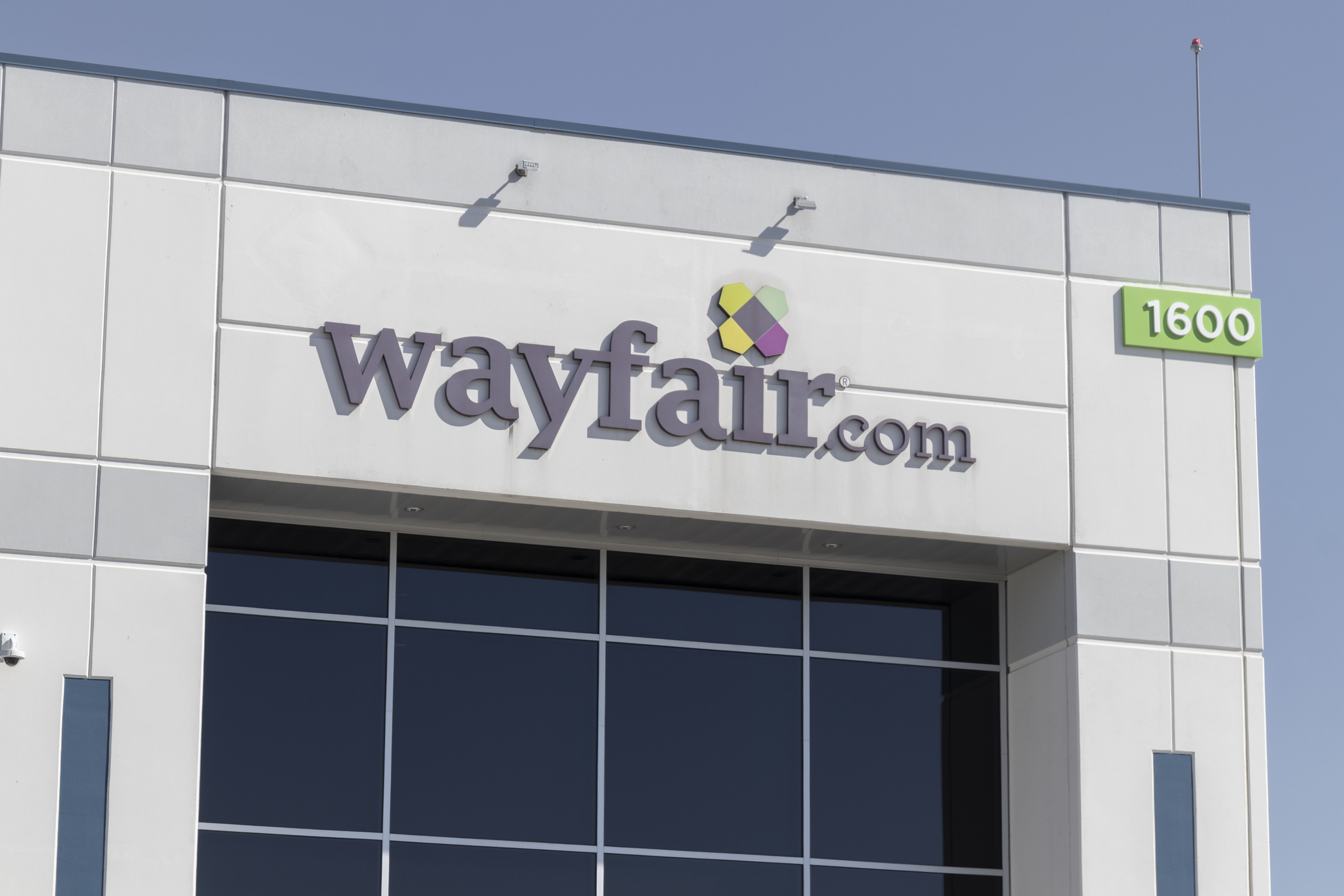 Closeup of logo on top of Wayfair Distribution Center building in Erlanger, Kentucky against a blue sky
