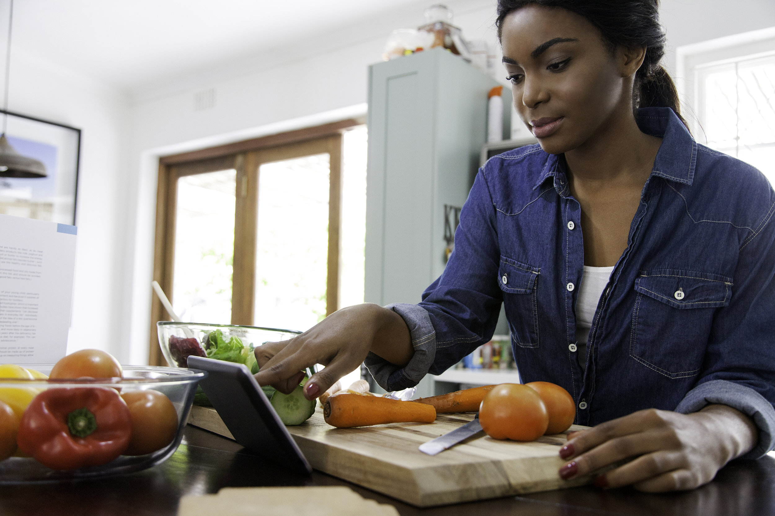 Woman reading a recipe while cooking