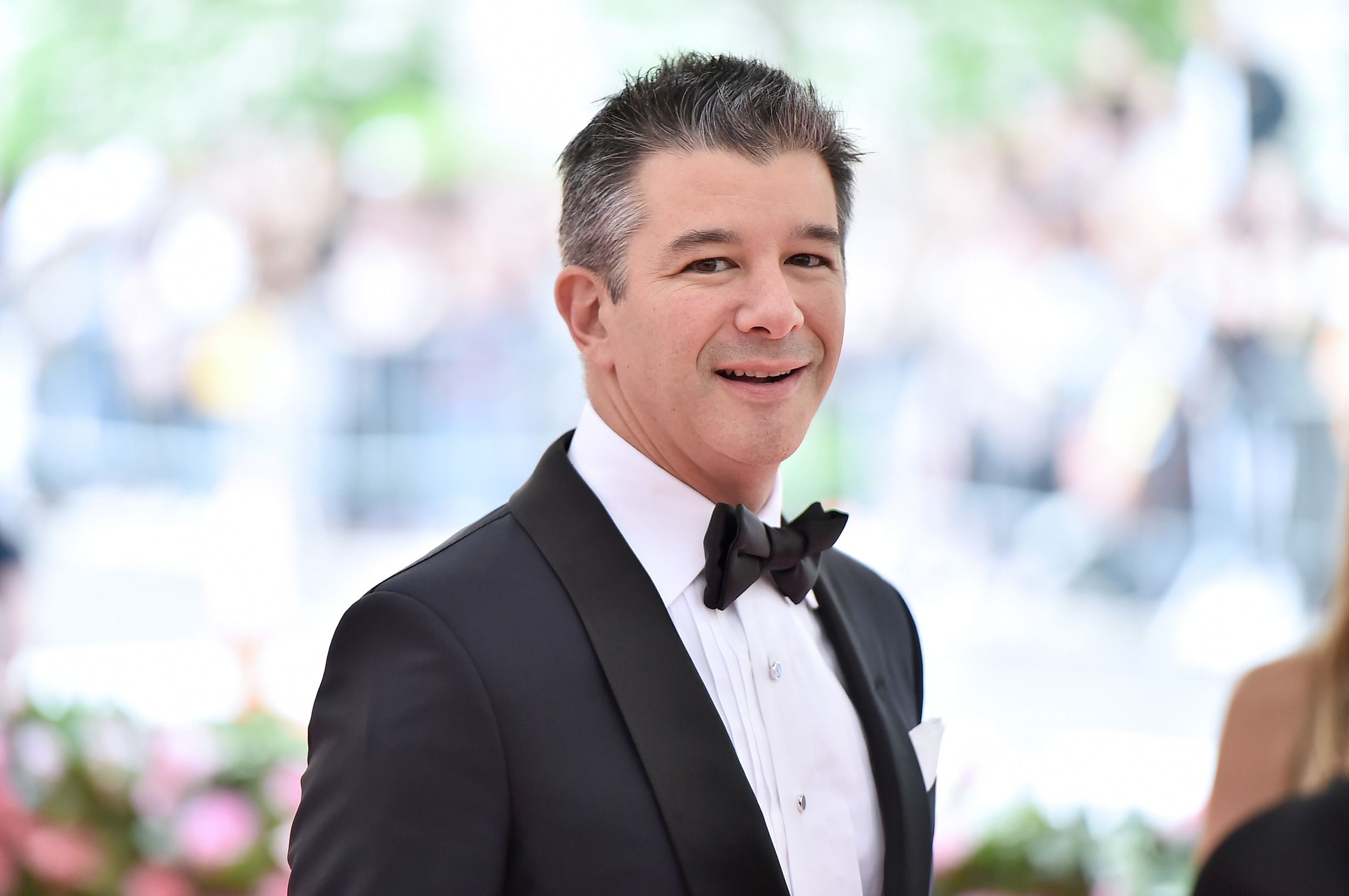 Travis Kalanick attends the 2019 Met Gala Celebrating Camp: Notes on Fashion at the Metropolitan Museum of Art, New York City, 2019, blurred background of garden scenery
