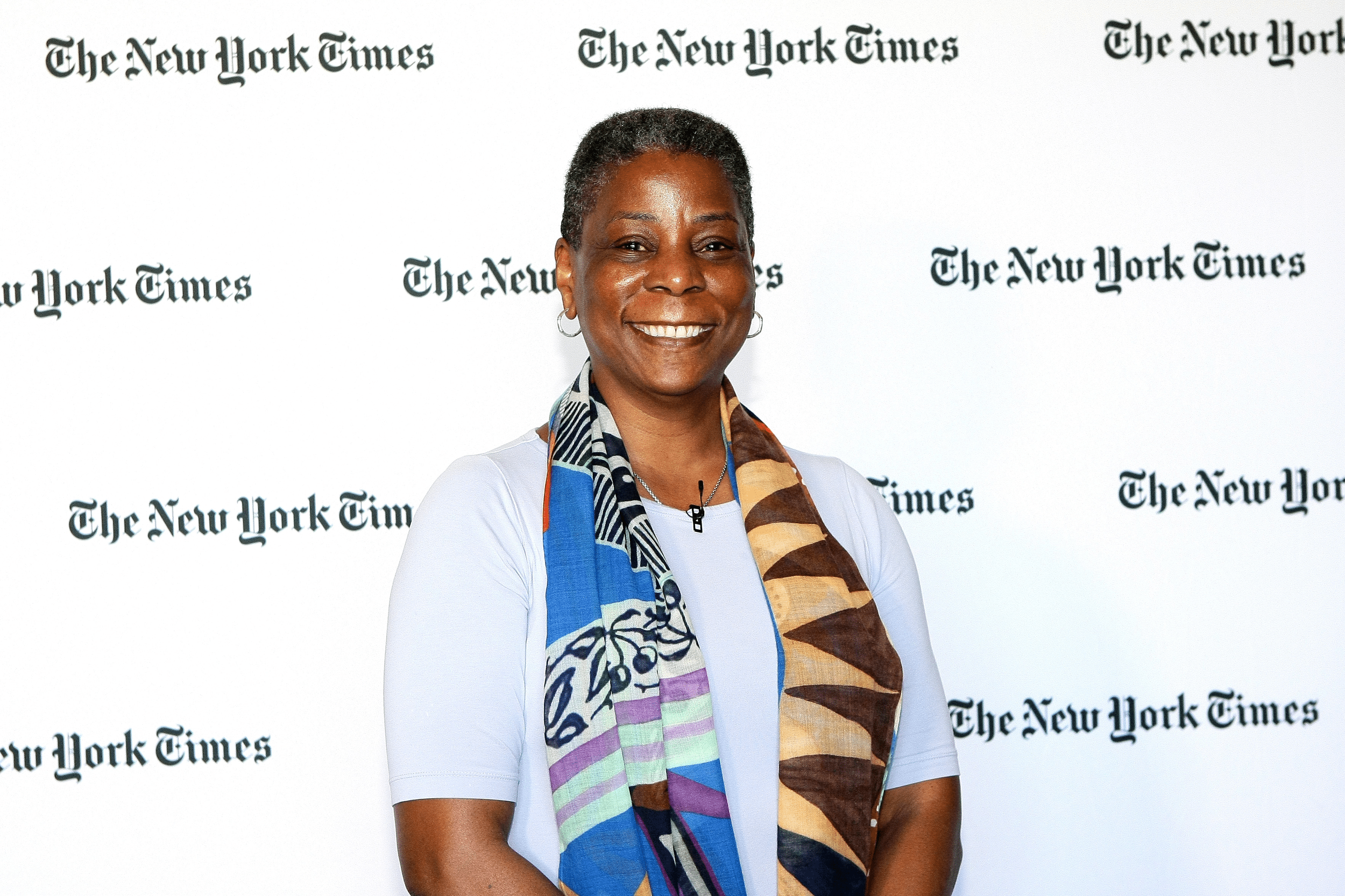 Ursula Burns speaks onstage at The New York Times New Work Summit, Half Moon Bay, California, 2016, white background with the NYT logo