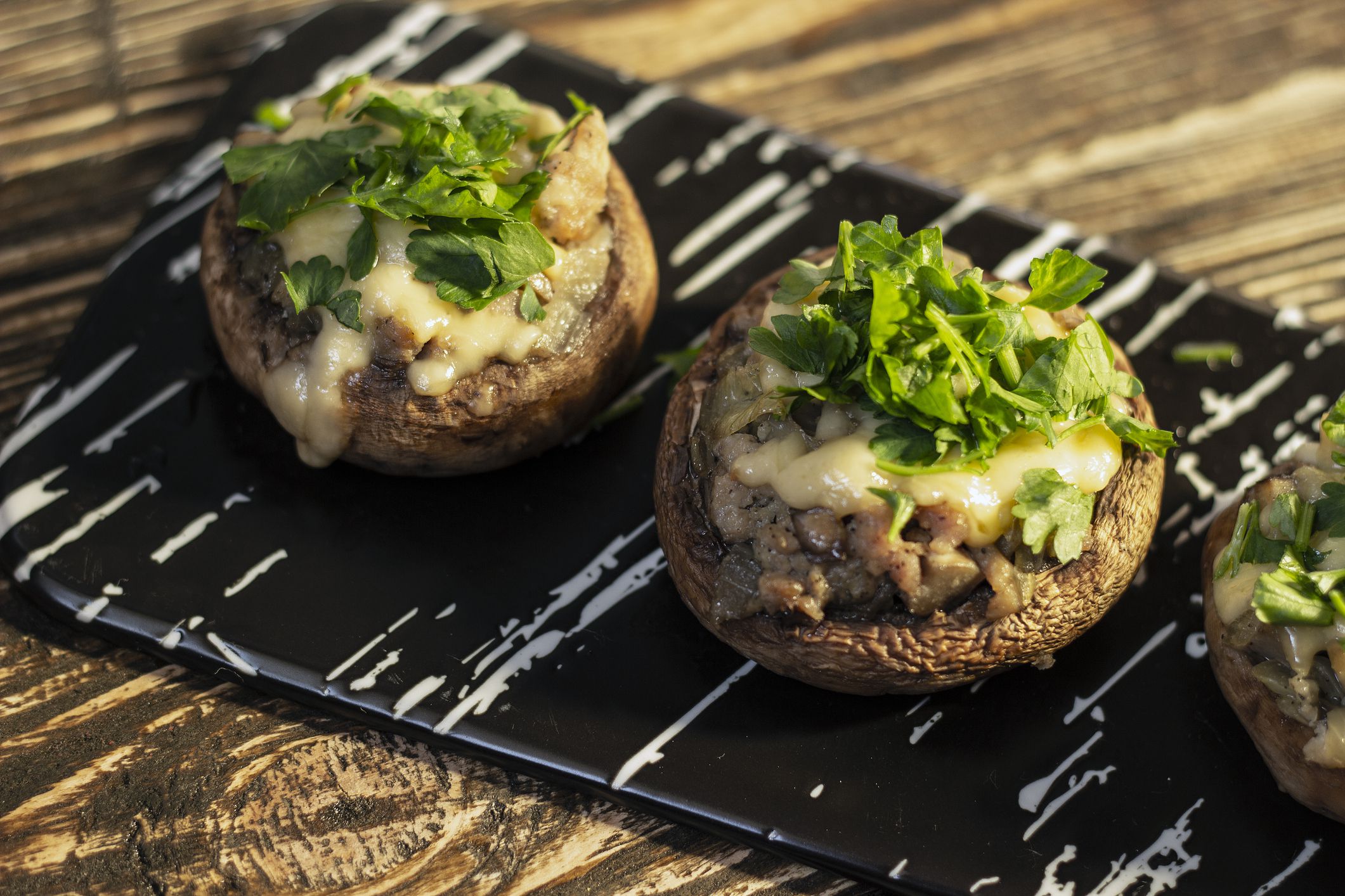 Stuffed mushrooms on a rough wooden surface