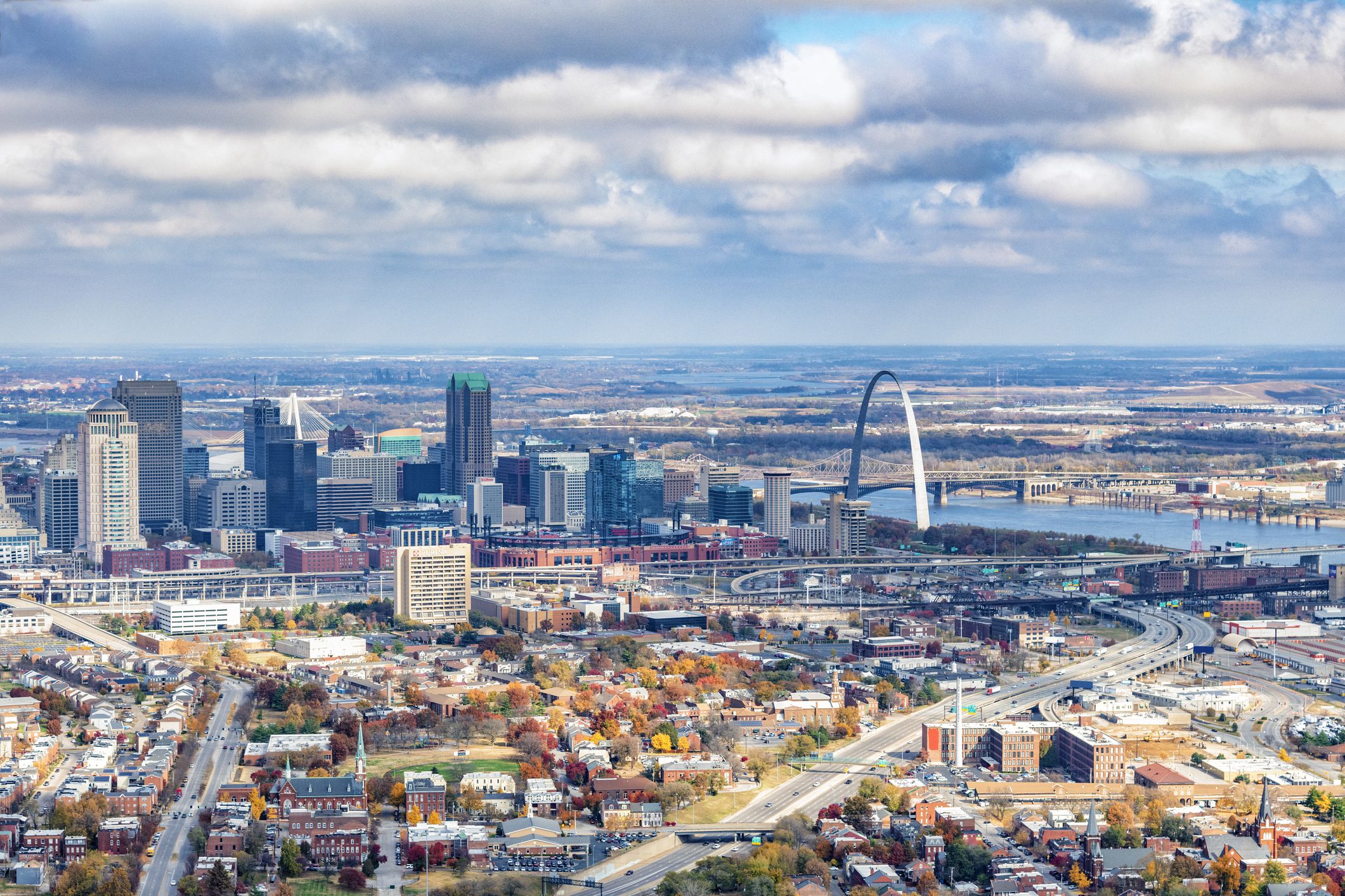 The skyline of St. Louis, Missouri along the banks of the Mississippi River shot from a distance at an altitude of about 1000 feet.