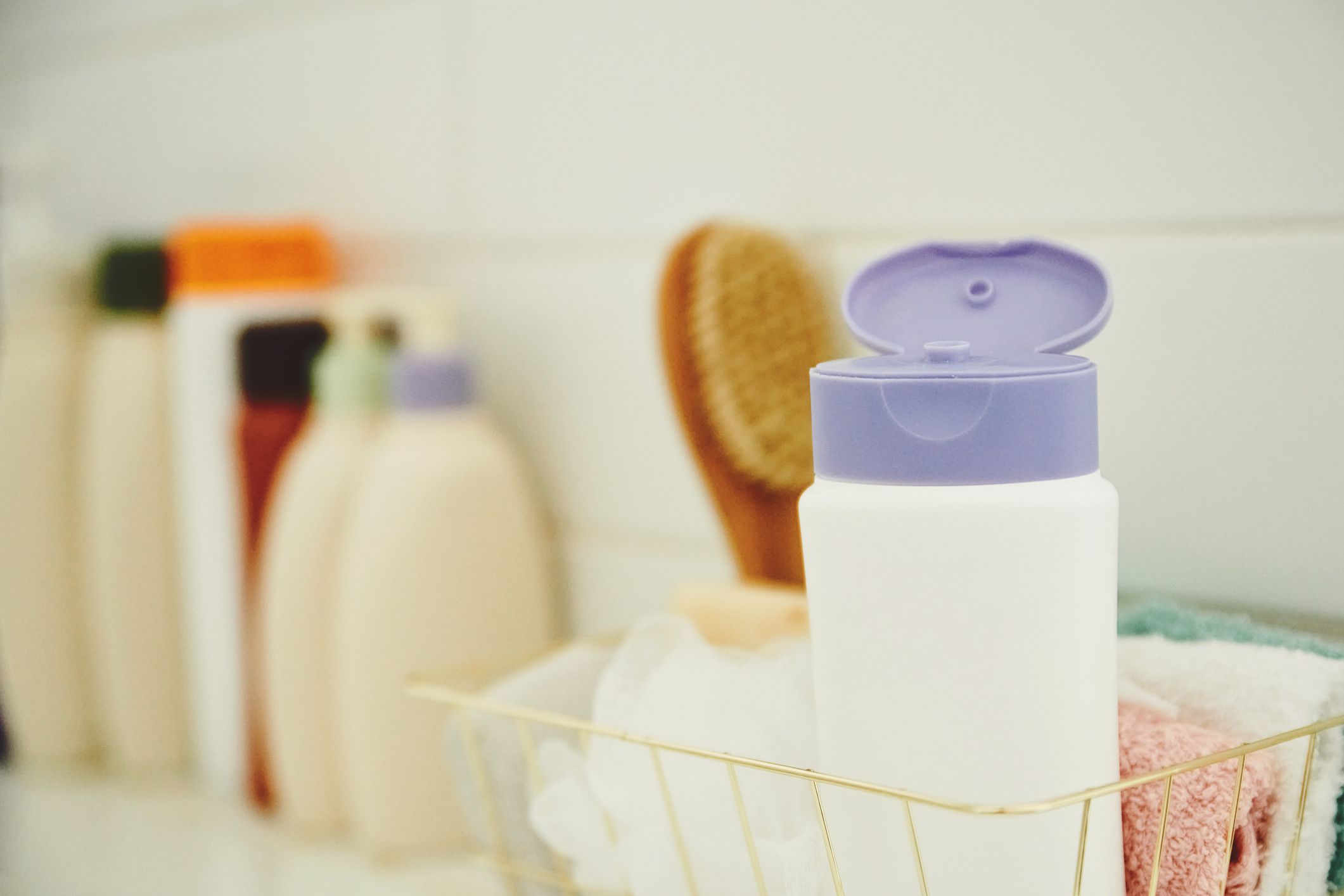 Collection of personal care products in bright modern bathroom shower