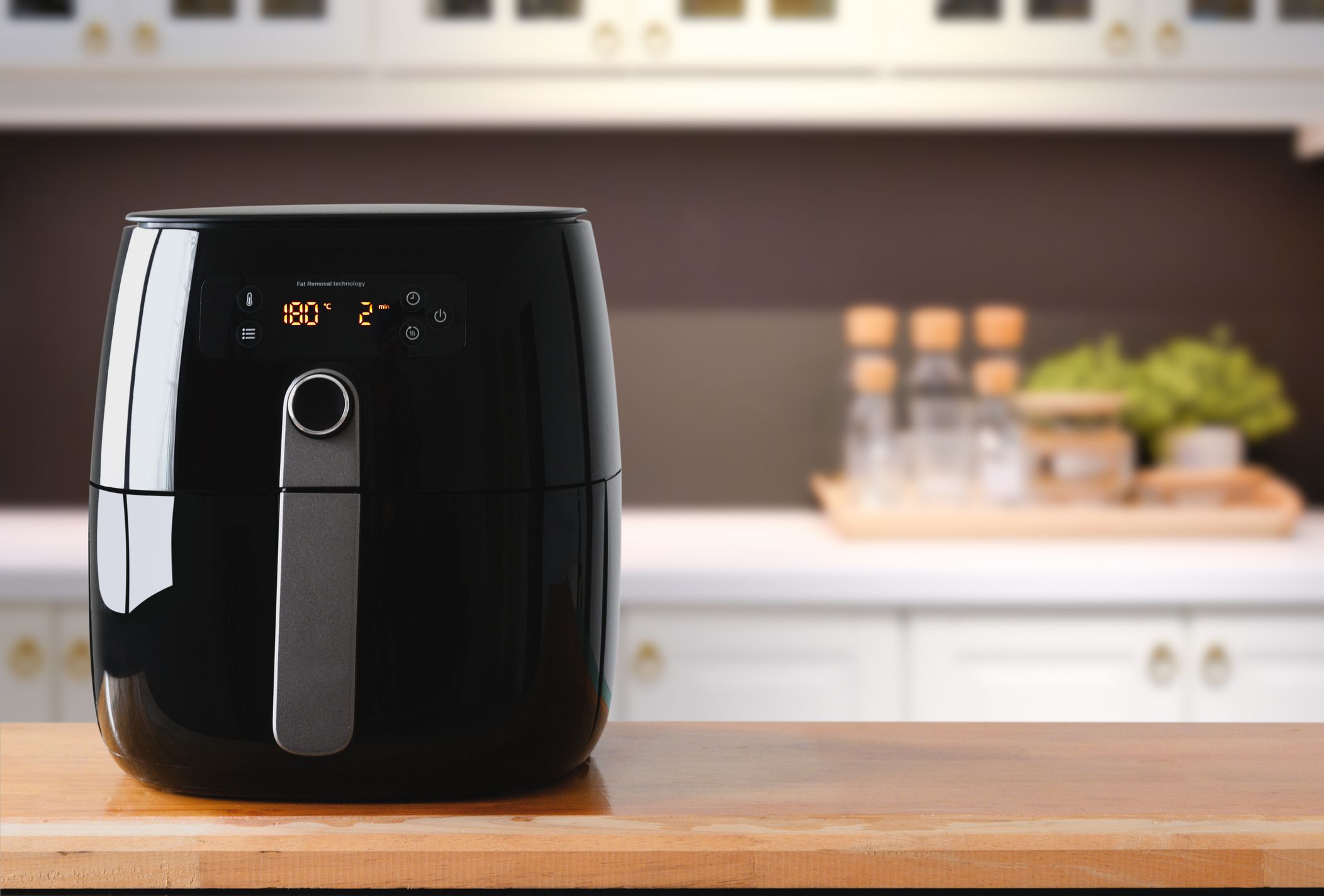Air fryer machine cooking potato fried in kitchen. Lifestyle of new normal cooking.