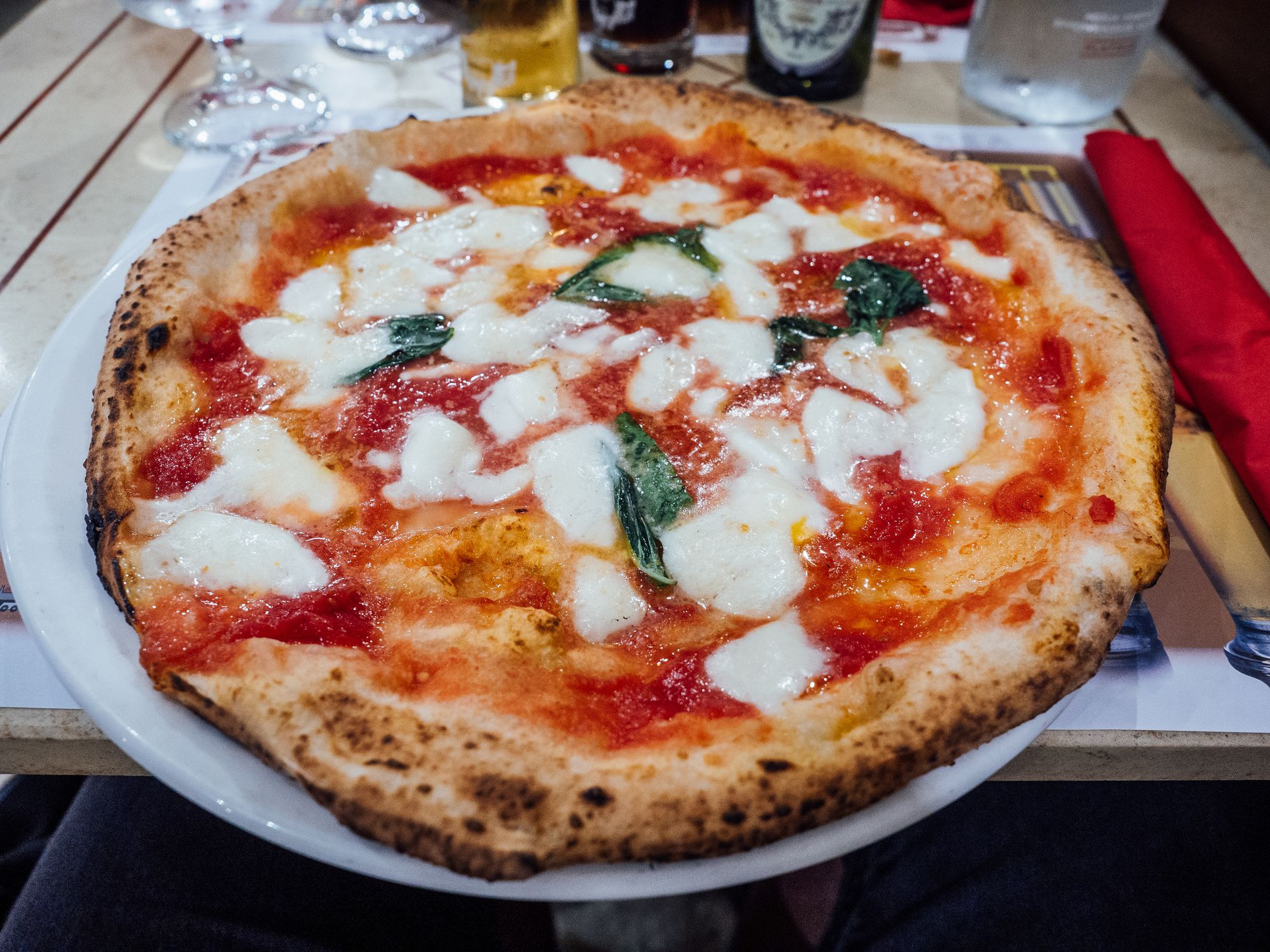 Eating pizza in a restaurant in Naples, Italy. Pov view.