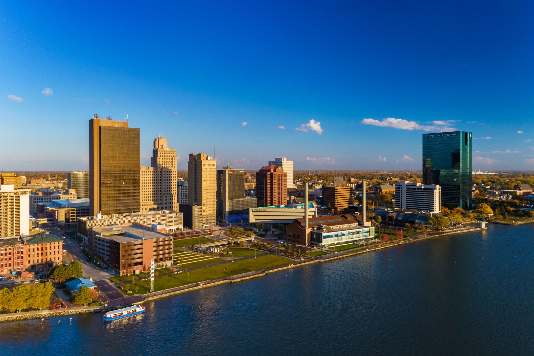 Downtown Toledo, Ohio skyline aerial view during the early morning golden hour, with the Maumee River in the foreground.