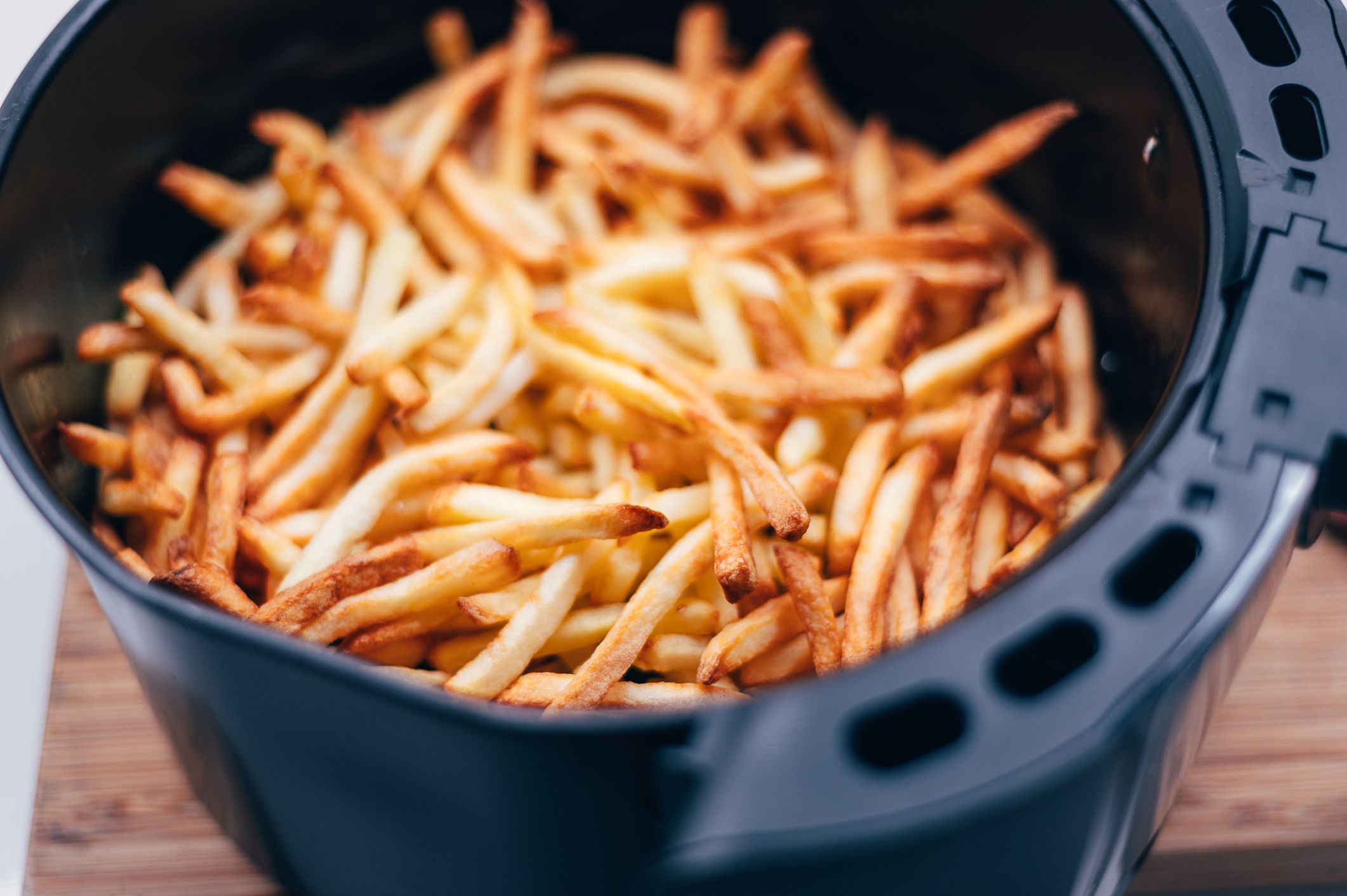 Chips or french fries made in tendy kitchen gadget air fryer, small countertop convection oven, deep fast frying oil free, more healthful way to cook deep-fried food