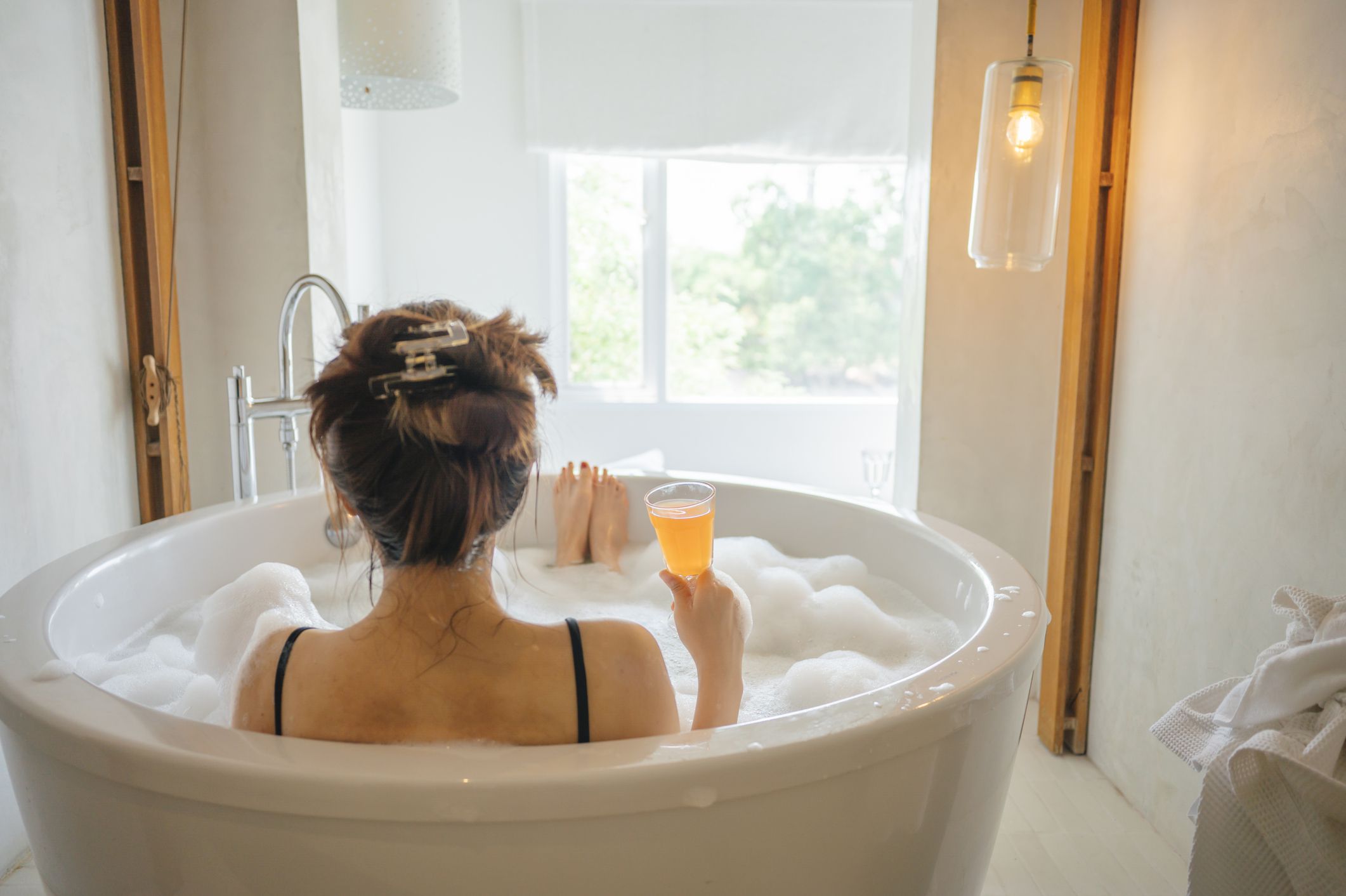 high angle view Chilling day asian chinese beautiful woman relaxing in bathtub in summer staycation
