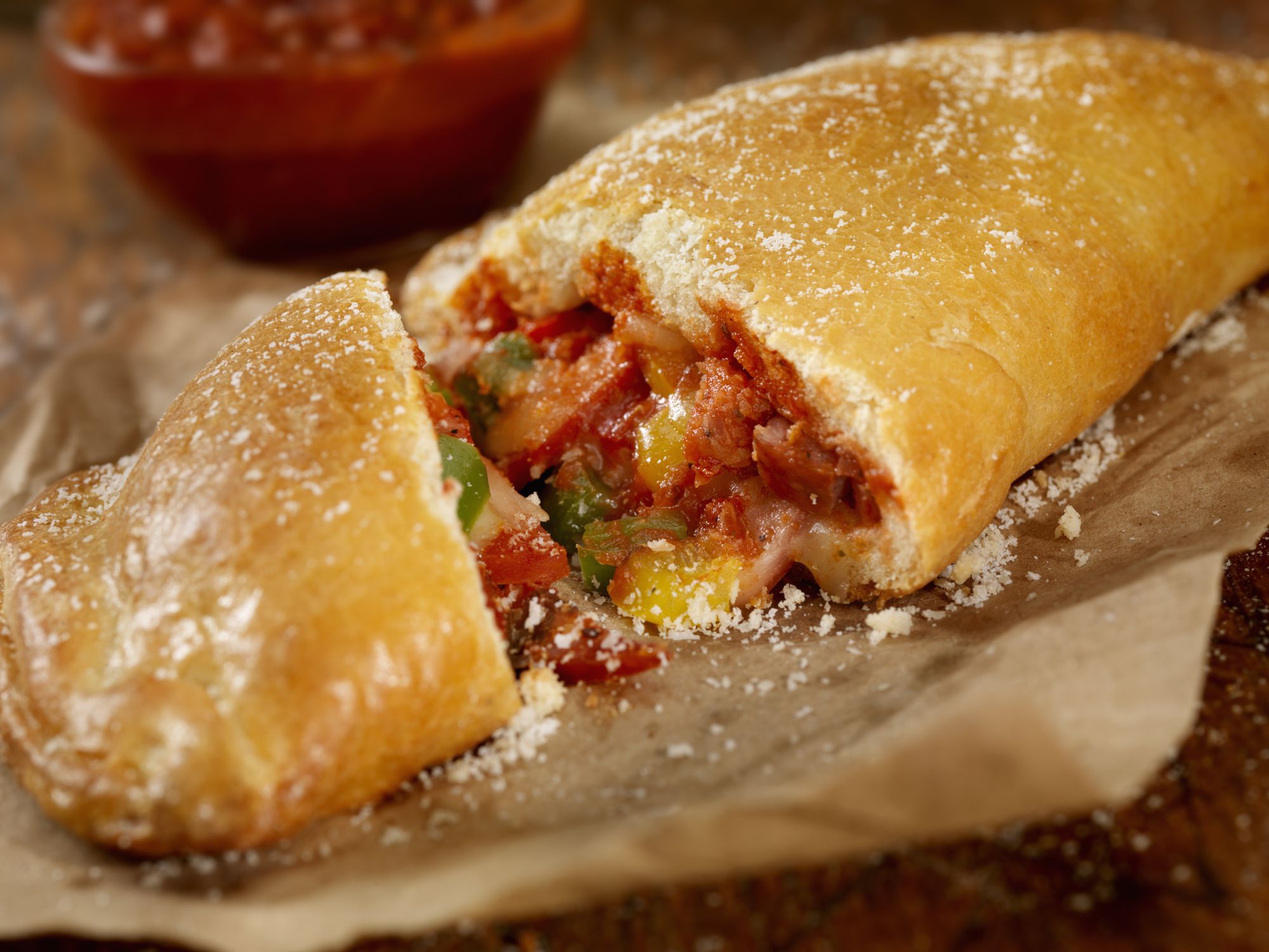 Authentic Hand Made Italian Calzone with Pepperoni, Sausage, Peppers, Fresh Parmesan and Marinara Sauce - Photographed on a Hasselblad H3D11-39 megapixel Camera System