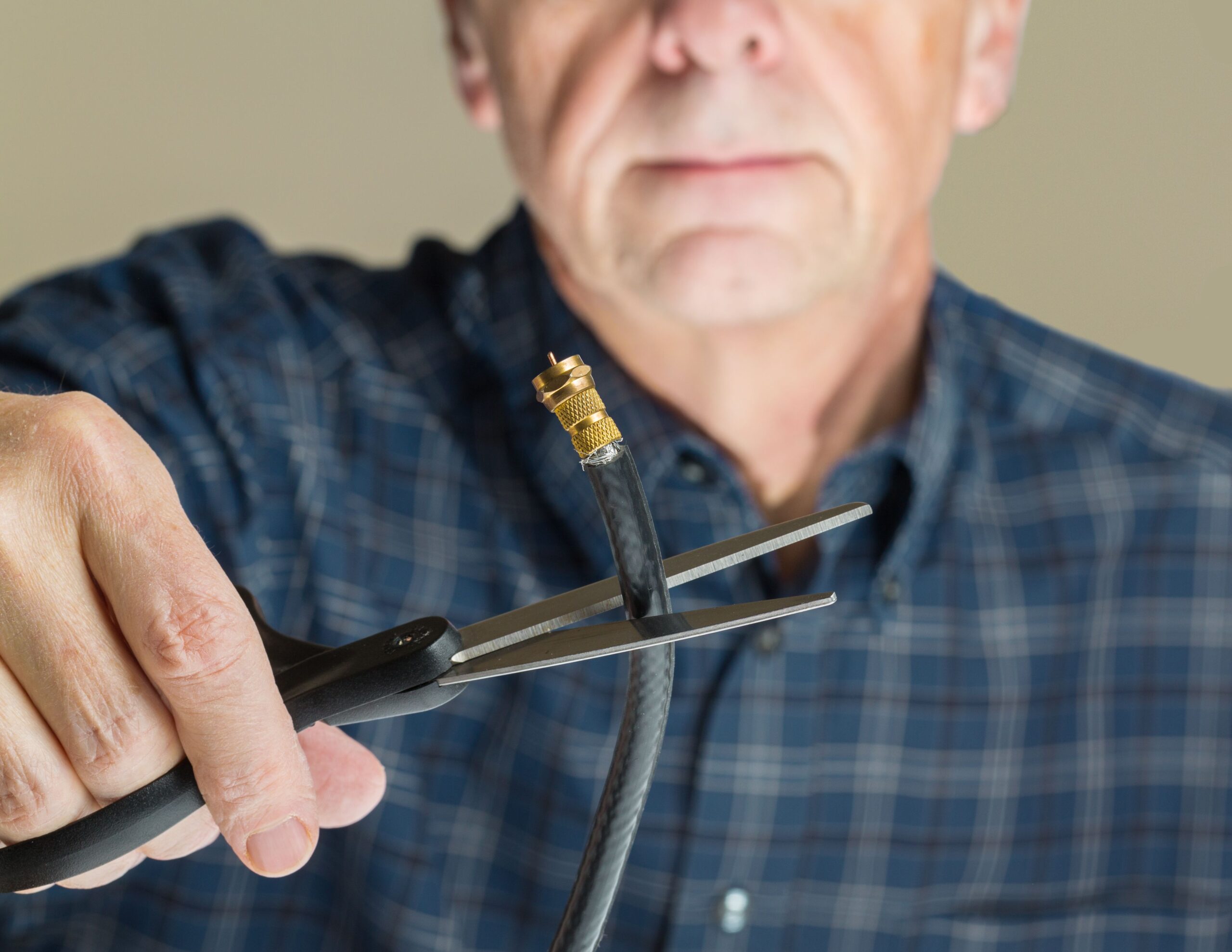 man cutting cable cord