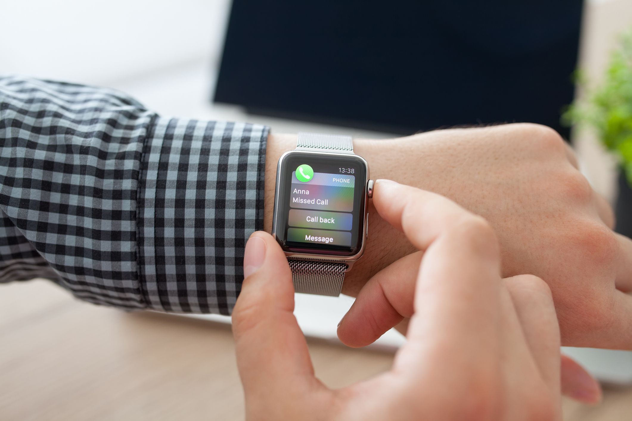 Alushta, Russia - August 11, 2015: Man hand with Apple Watch and missed phone call on the screen. Apple Watch was created and developed by the Apple inc.