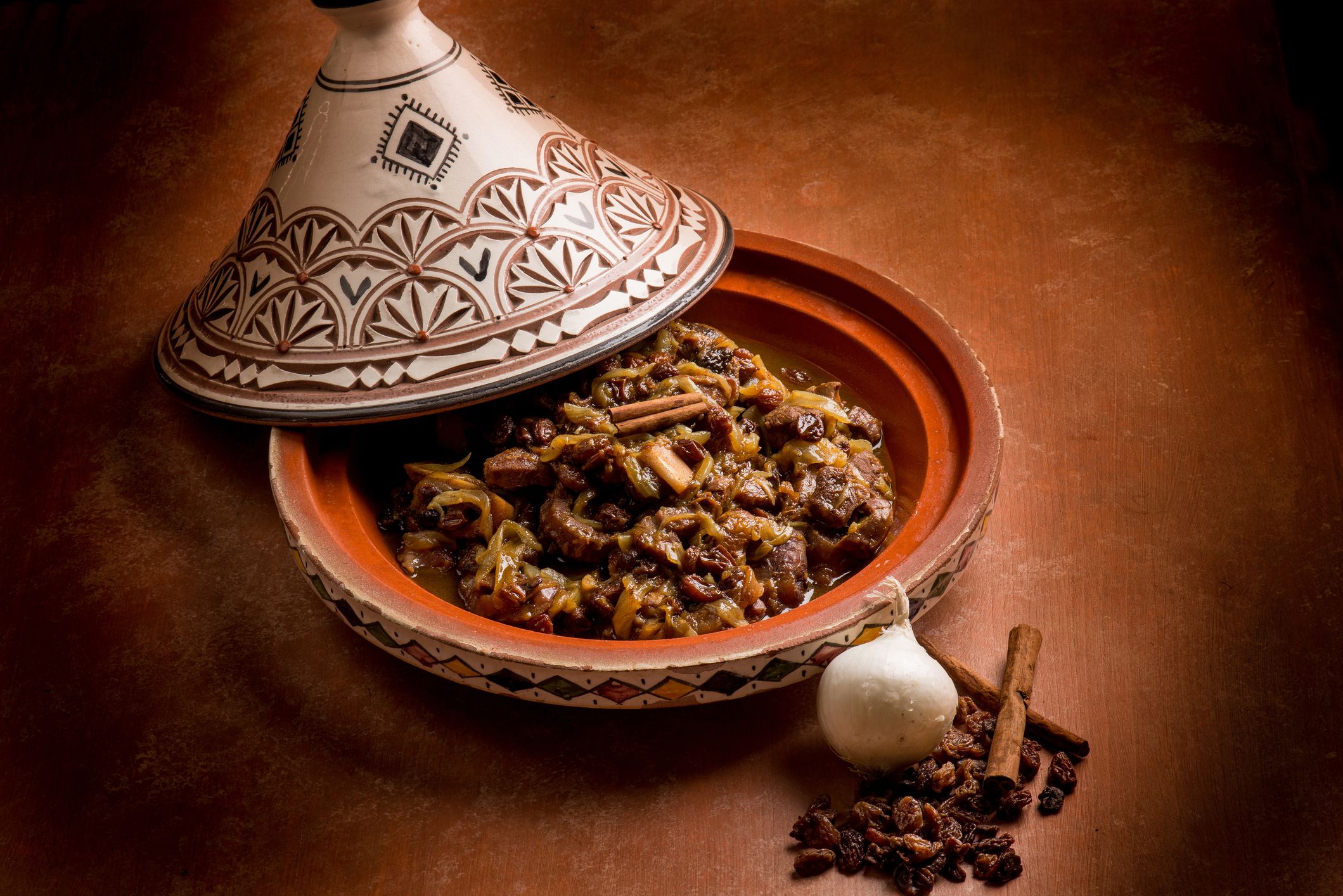 traditional tajine with meat, onion, dried grape and cinnamon