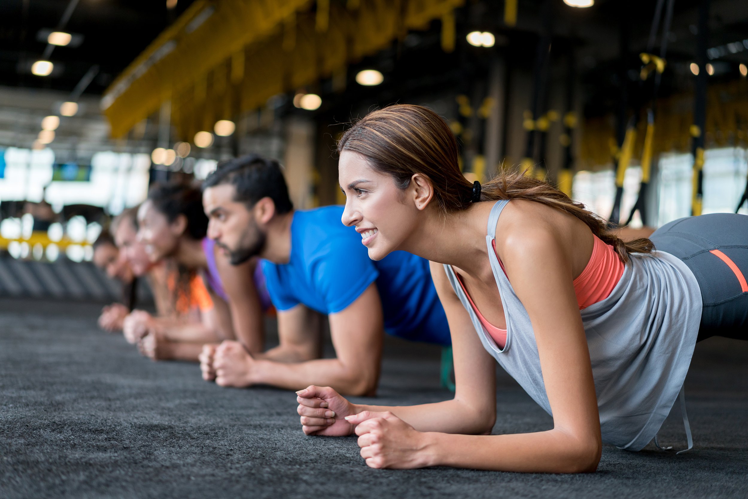 group of people at the gym in a suspension training class