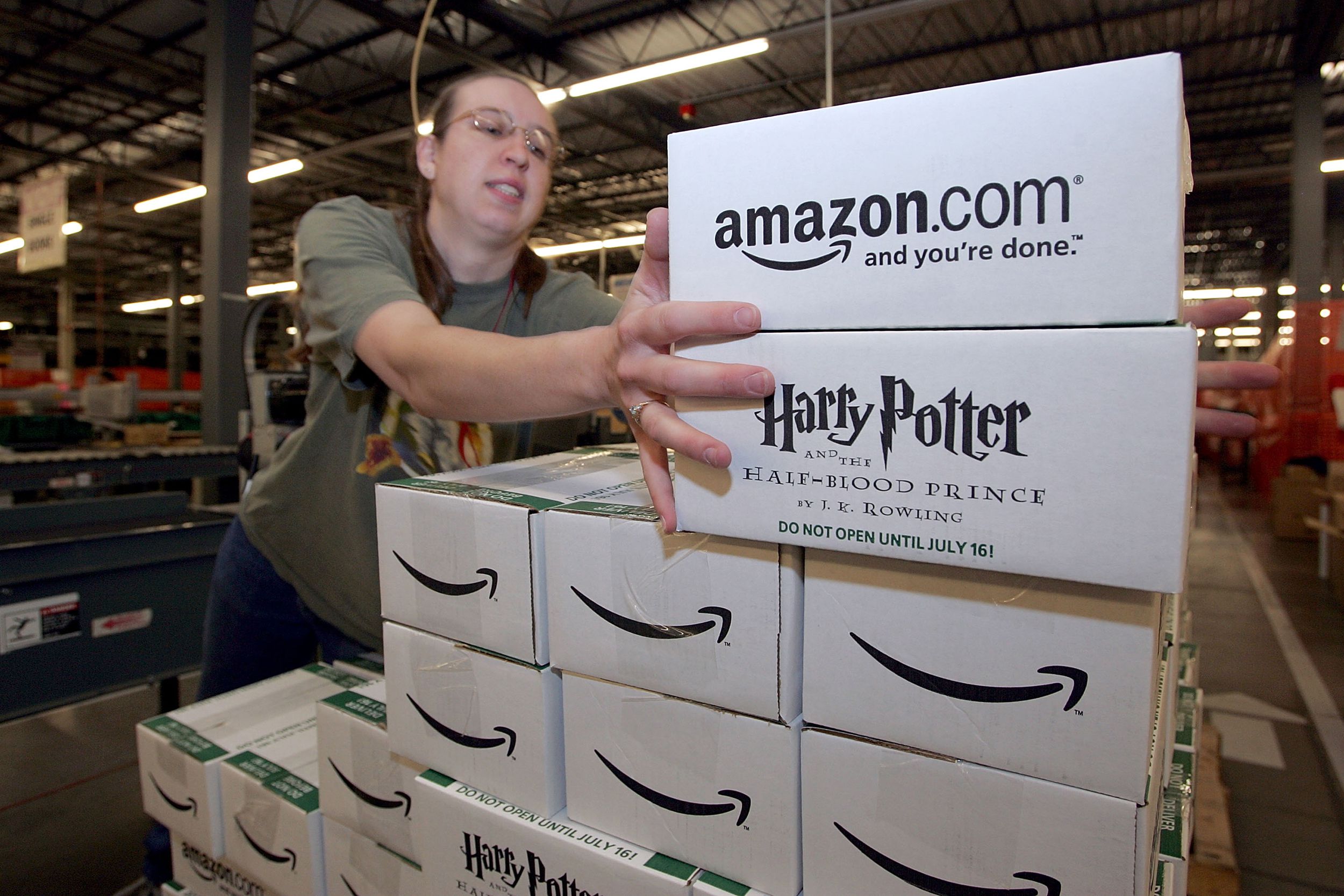 Amazon.com worker Jennifer Bladow moves pre-packaged copies of the new Harry Potter and the Half Blood Prince, by author J. K. Rowling on a conveyor belt at the Amazon.com shipping facility July 11, 2005 in Fernley, Nevada.
