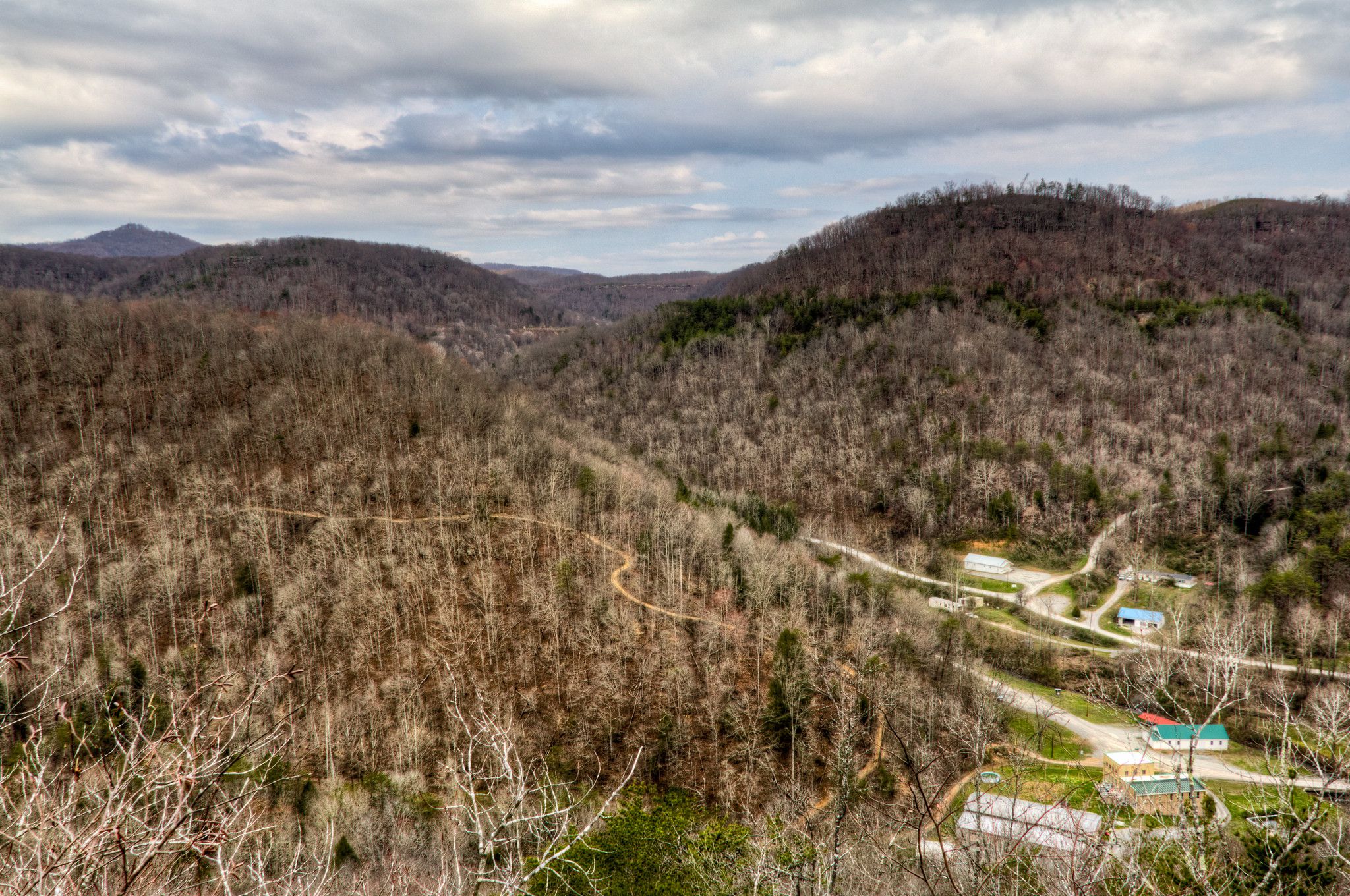 Overlook of mountains covered in leafless trees.