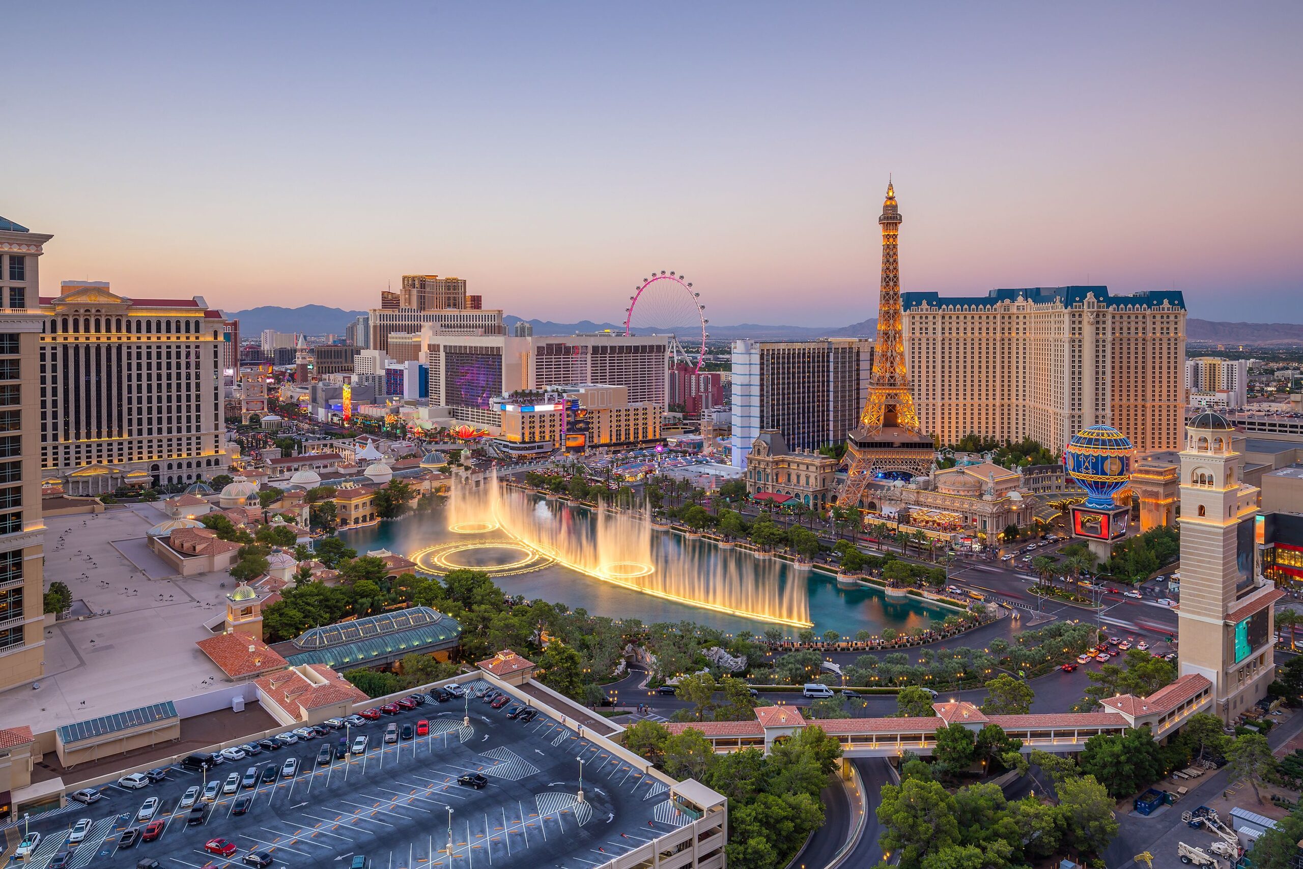 Aerial view of the strip in downtown Las Vegas during sunset with glittering lights of casinos and hotels