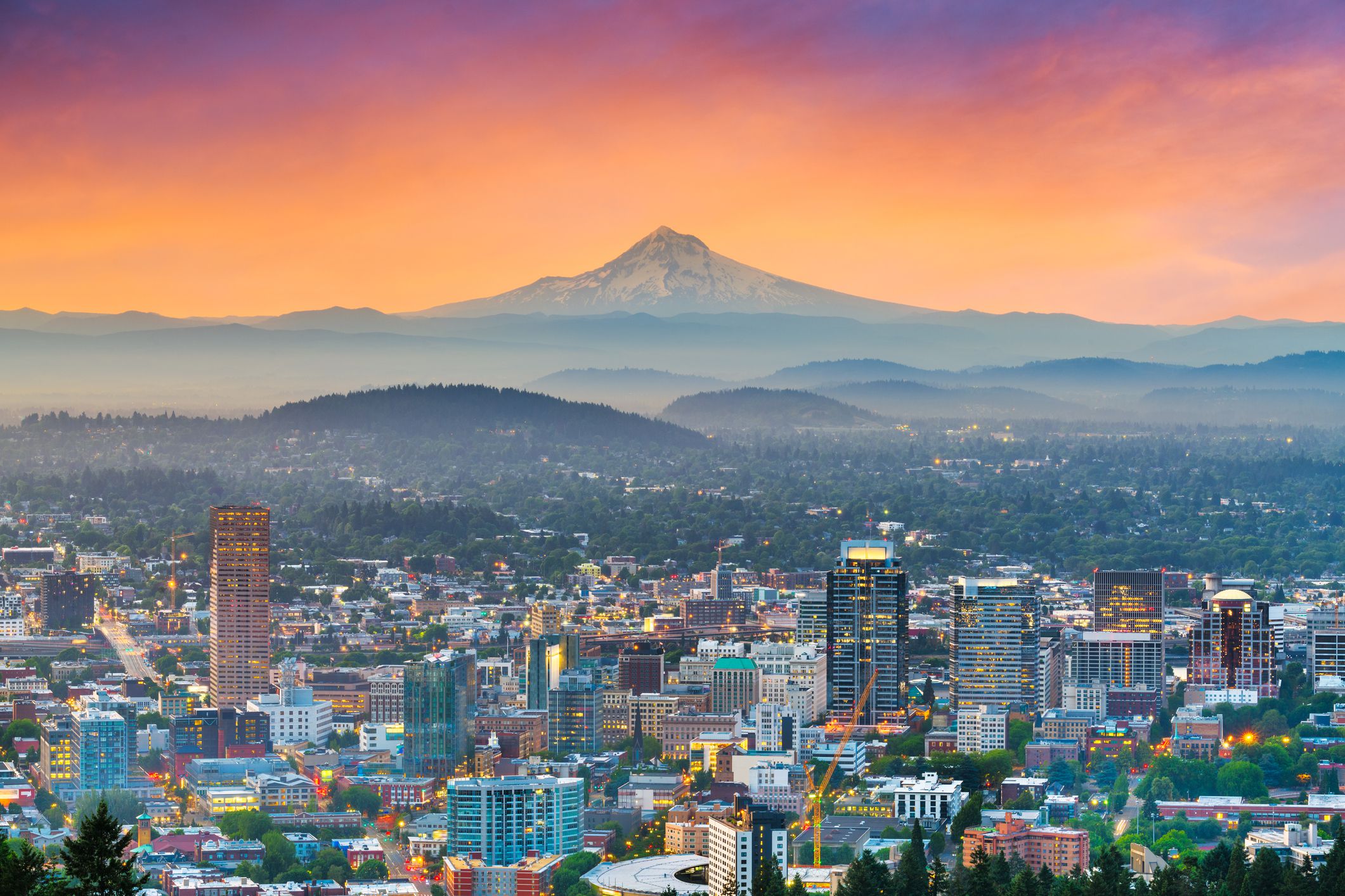 Aerial of downtown Portland, Oregon skyline with Mount Hood during a dramatic sunrise