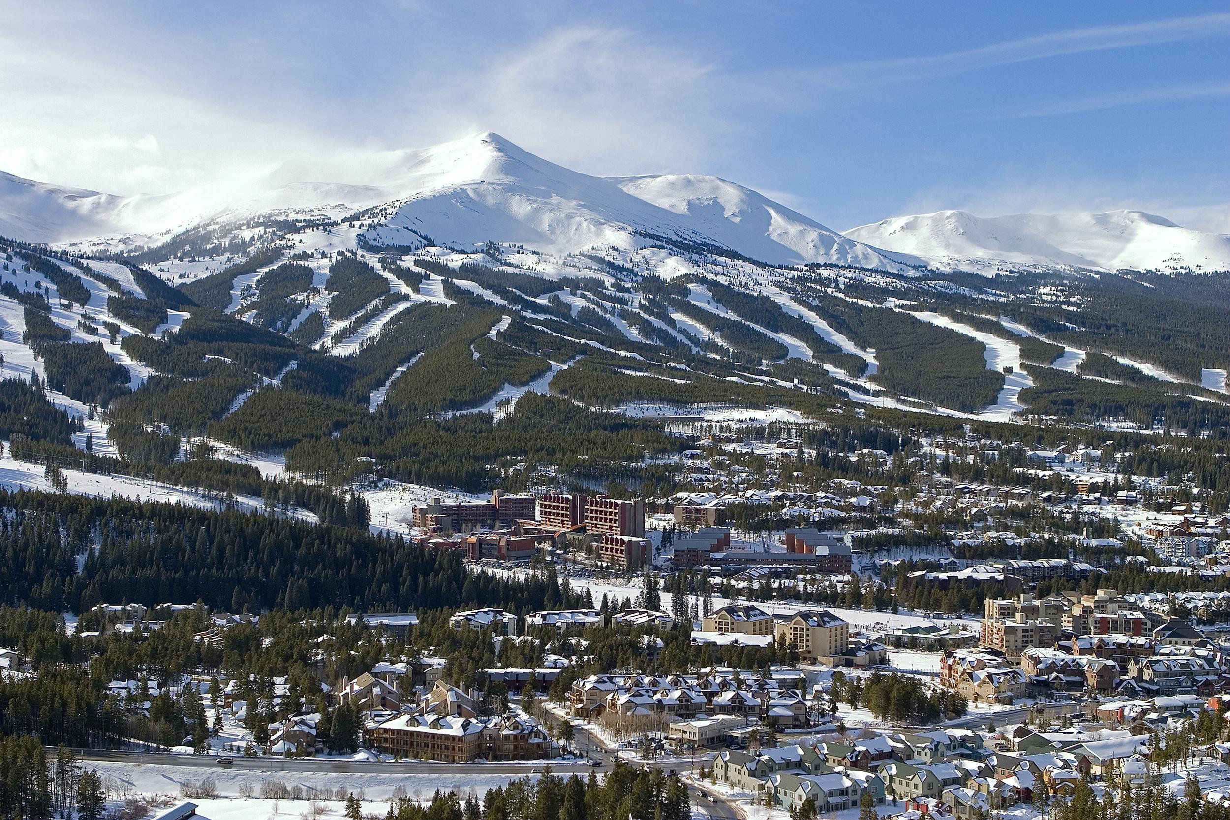Downtown and surrounding mountains of Breckenridge, Colorado with snow on a sunny day