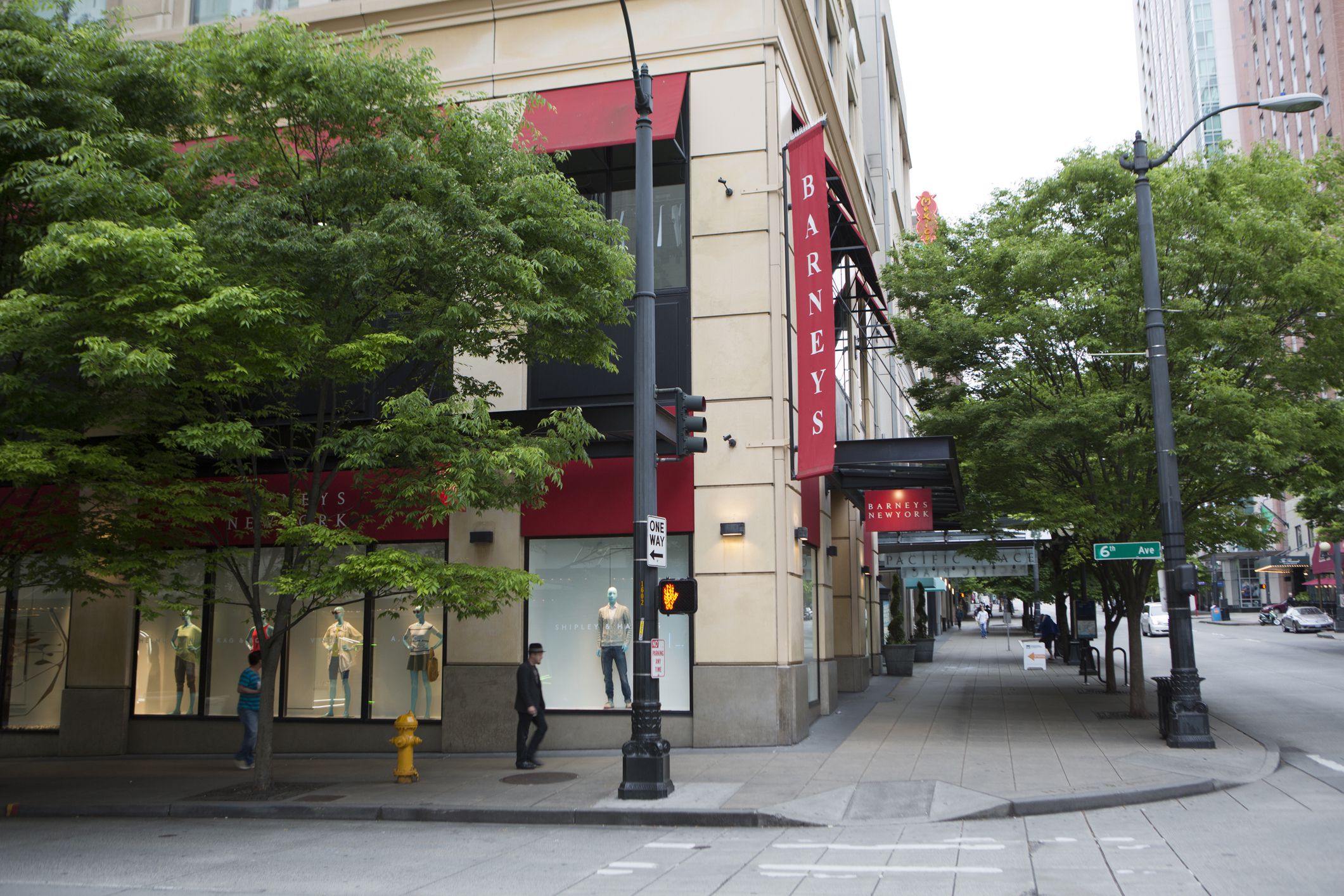 Exterior of Barneys in the Pacific Place Shopping Center, Seattle, at a corner of two roads on a cloudy day in summer