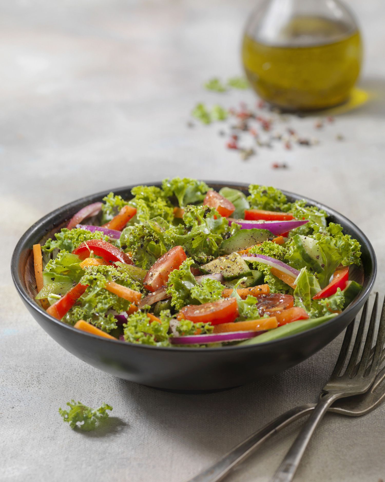 Kale salad in a black bowl