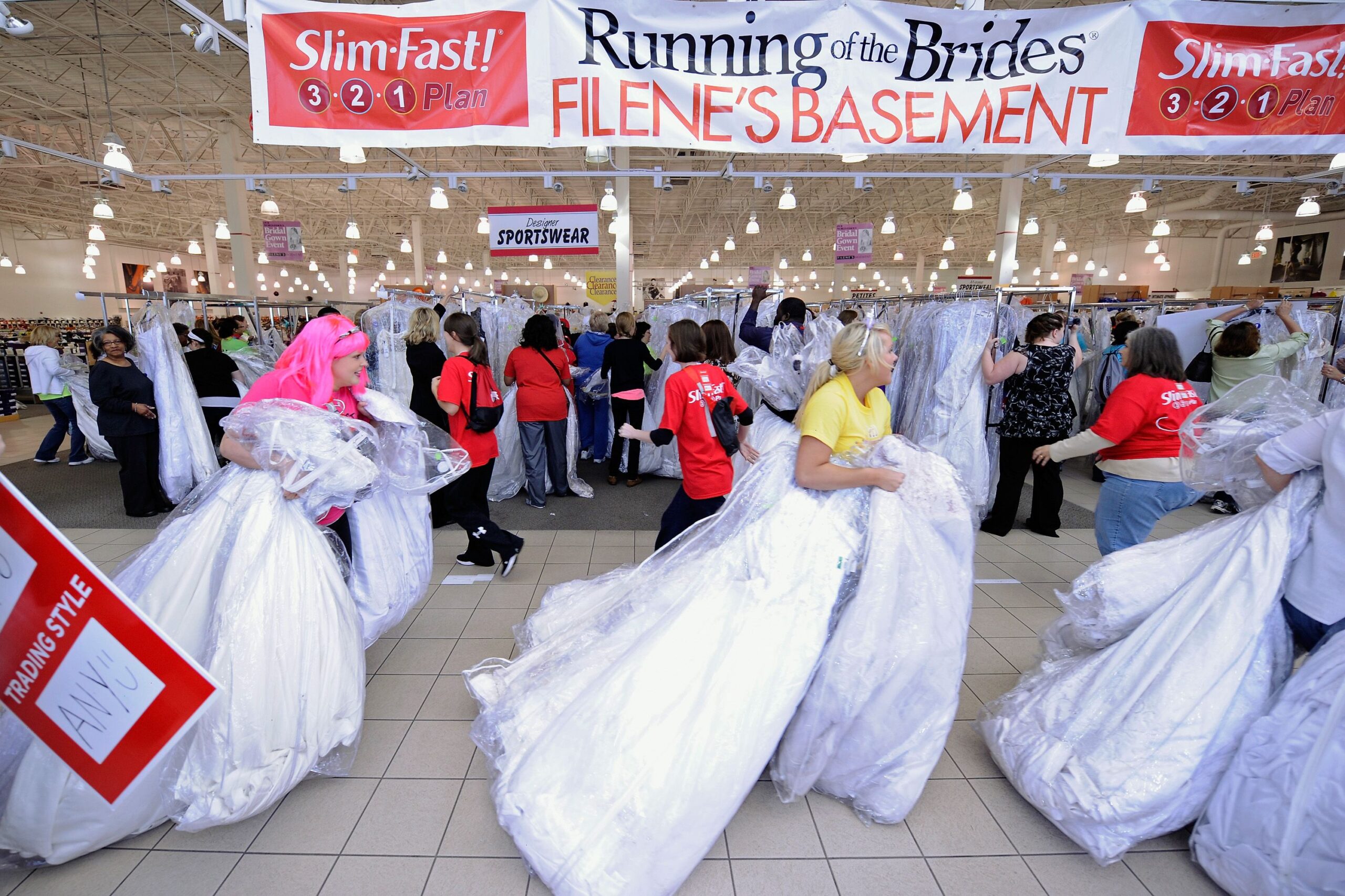 Last Slim-Fast sponsored 'Running of the Brides', Filene's Basement, Columbus, Ohio, several brides rushing with many wedding dresses in the foreground, many people looking at wedding dresses in the background