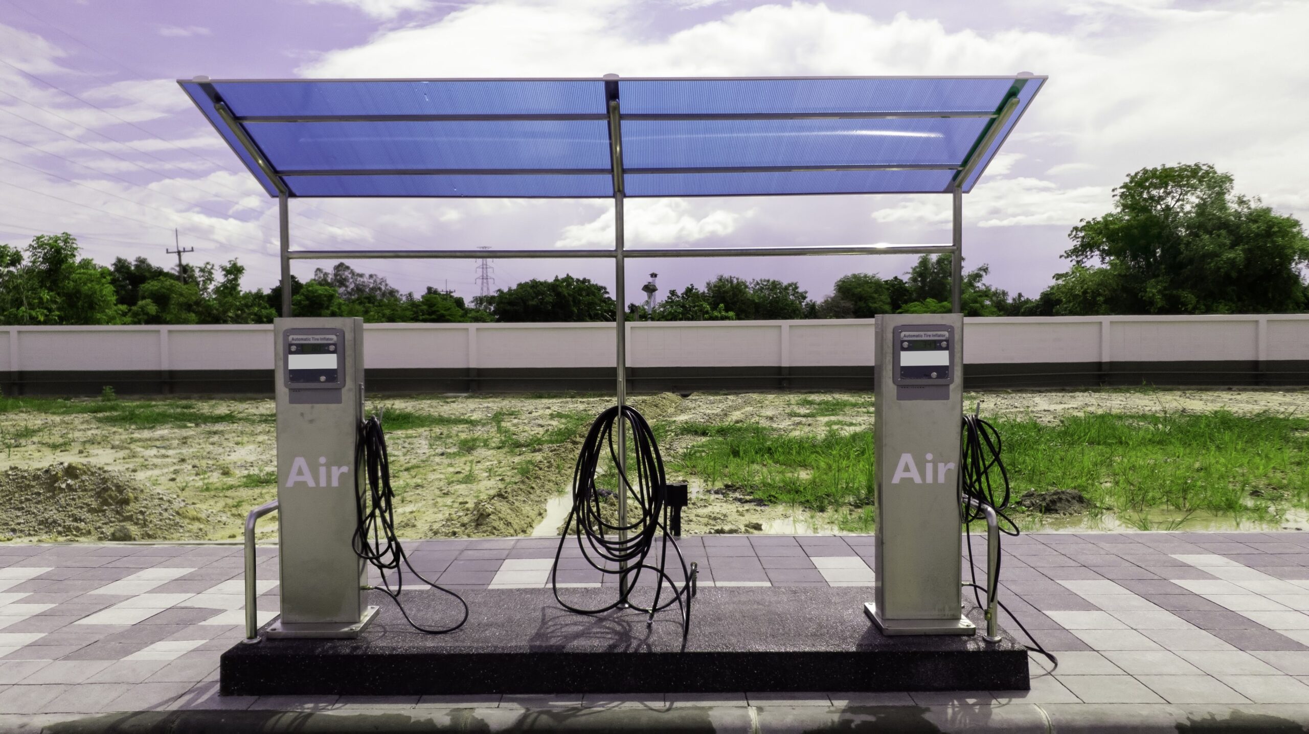 Tire tire inflator station with bright sky clouds, Air compressor inflator tank in oil pump