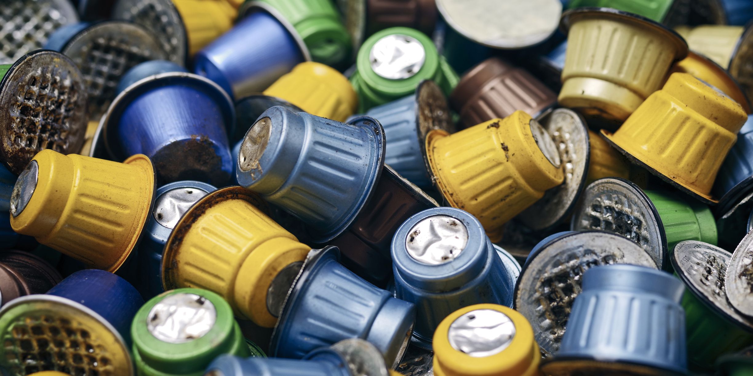 Used coffee capsules. Panoramic image with focus on foreground