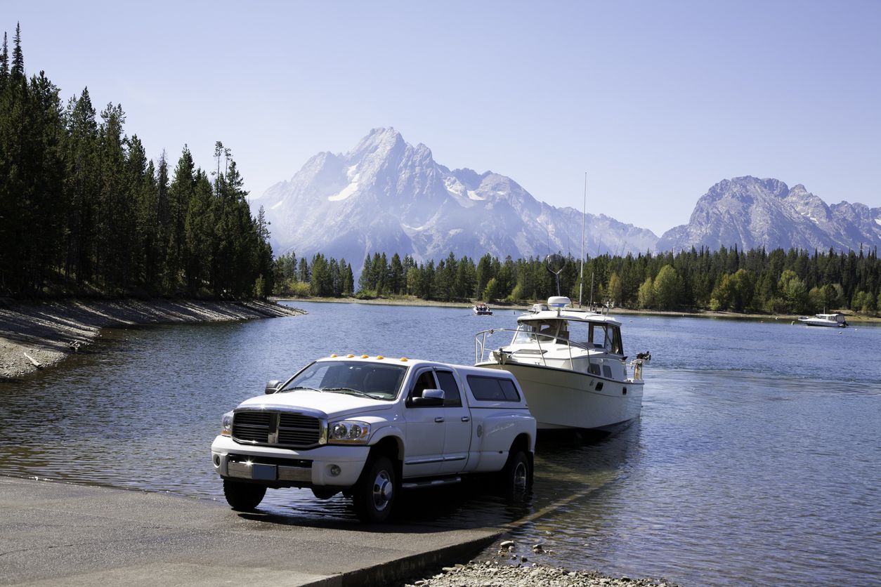 Pickup truck pulling boat out of water up ramp