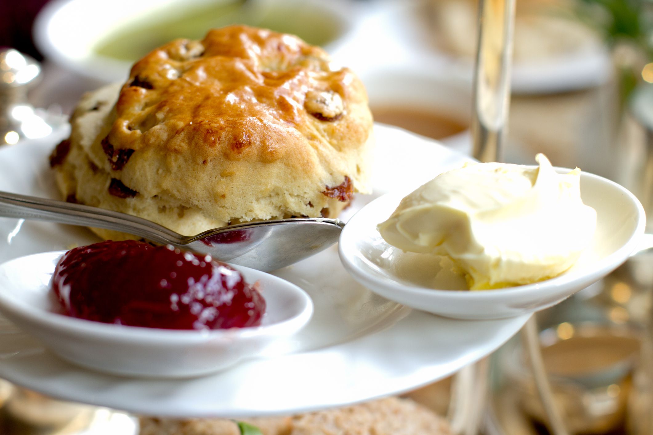 Fancy scone with clotted cream and jam for English style High Tea, shallow depth of field, focus on front of scone. This image was taken in York, England at a fancy tea house.