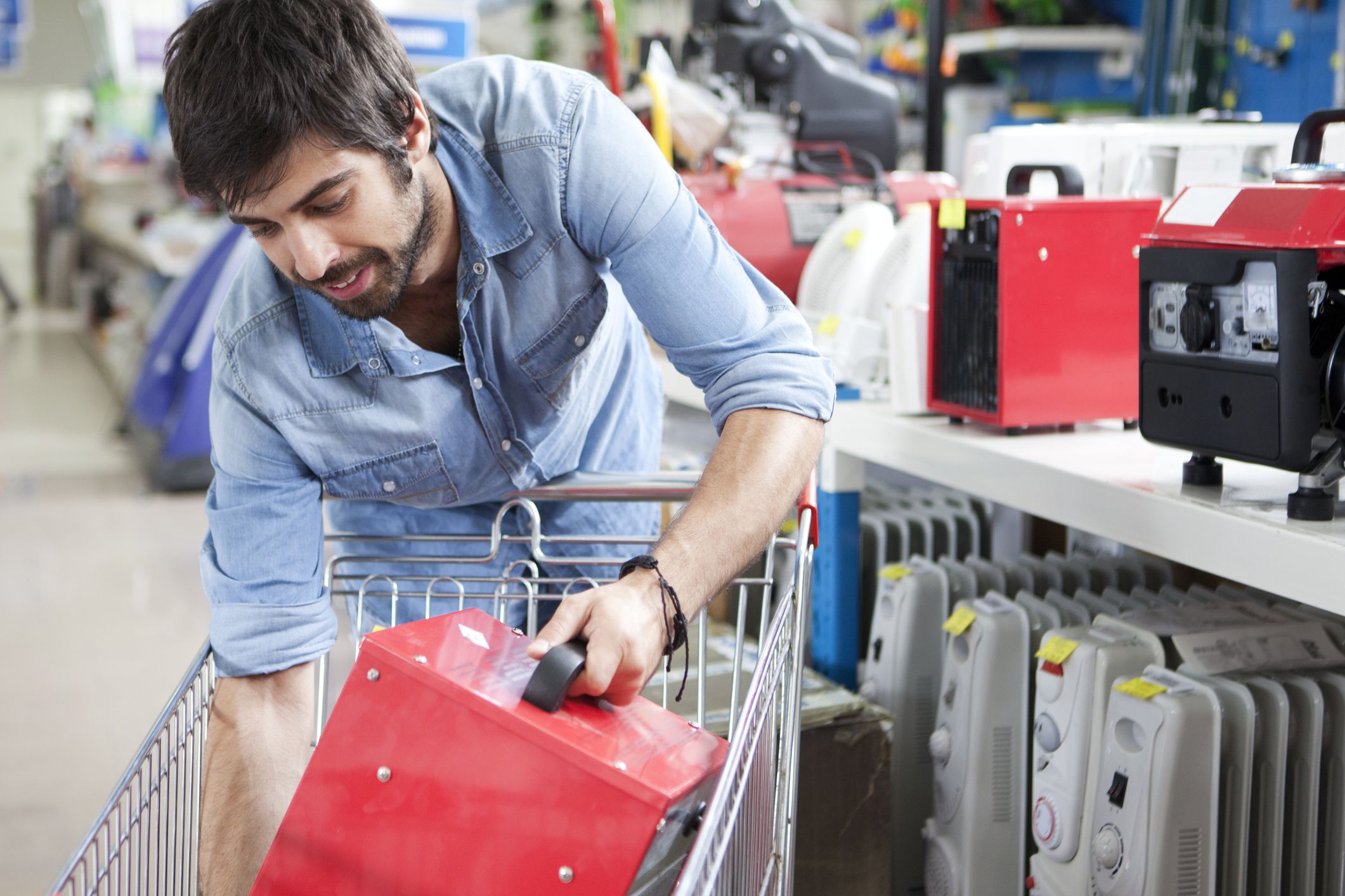 Male customer buying calorifier at hardware store