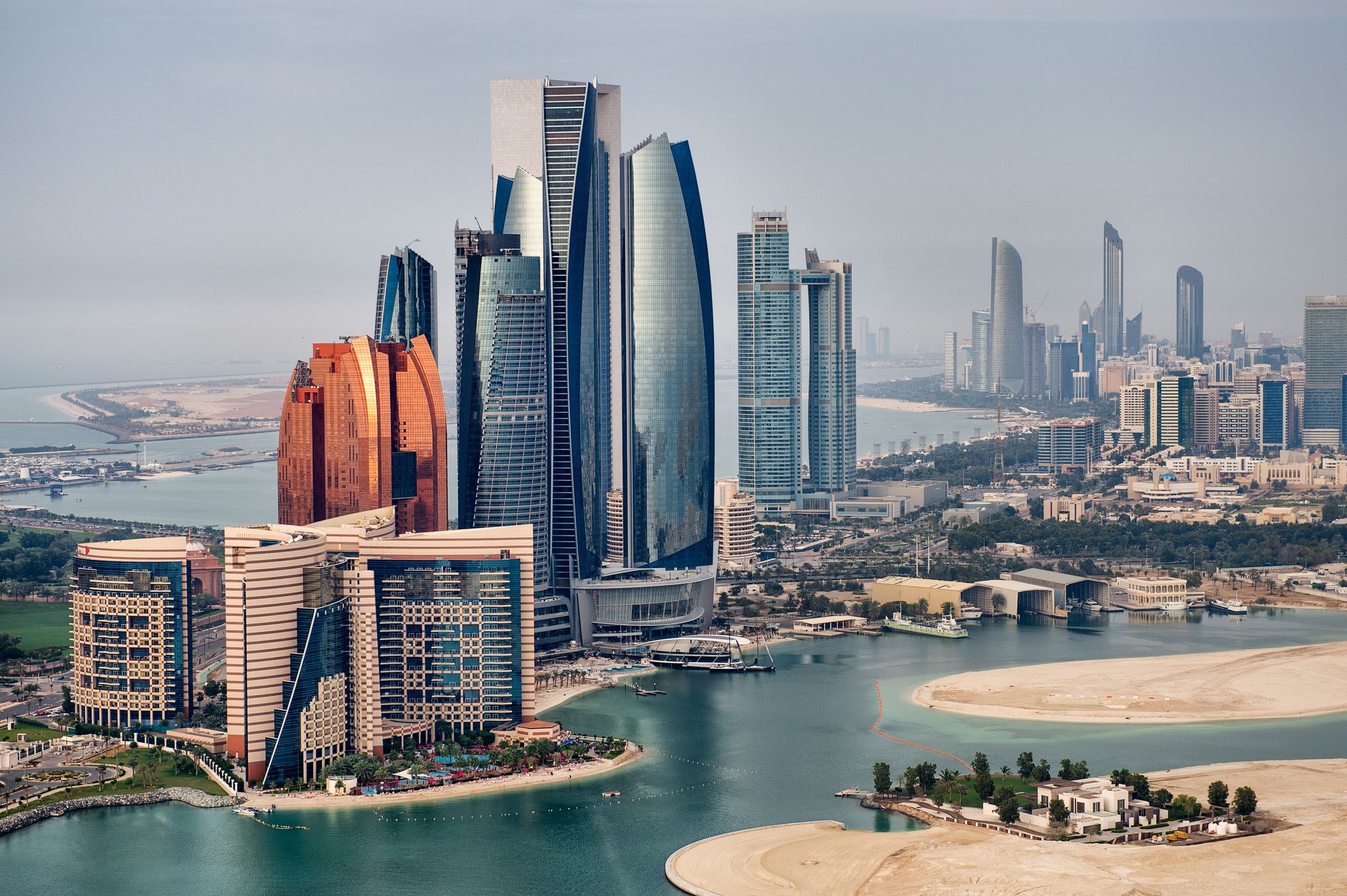 Helicopter point of view of Abu Dhabi skyline with surrounding area.